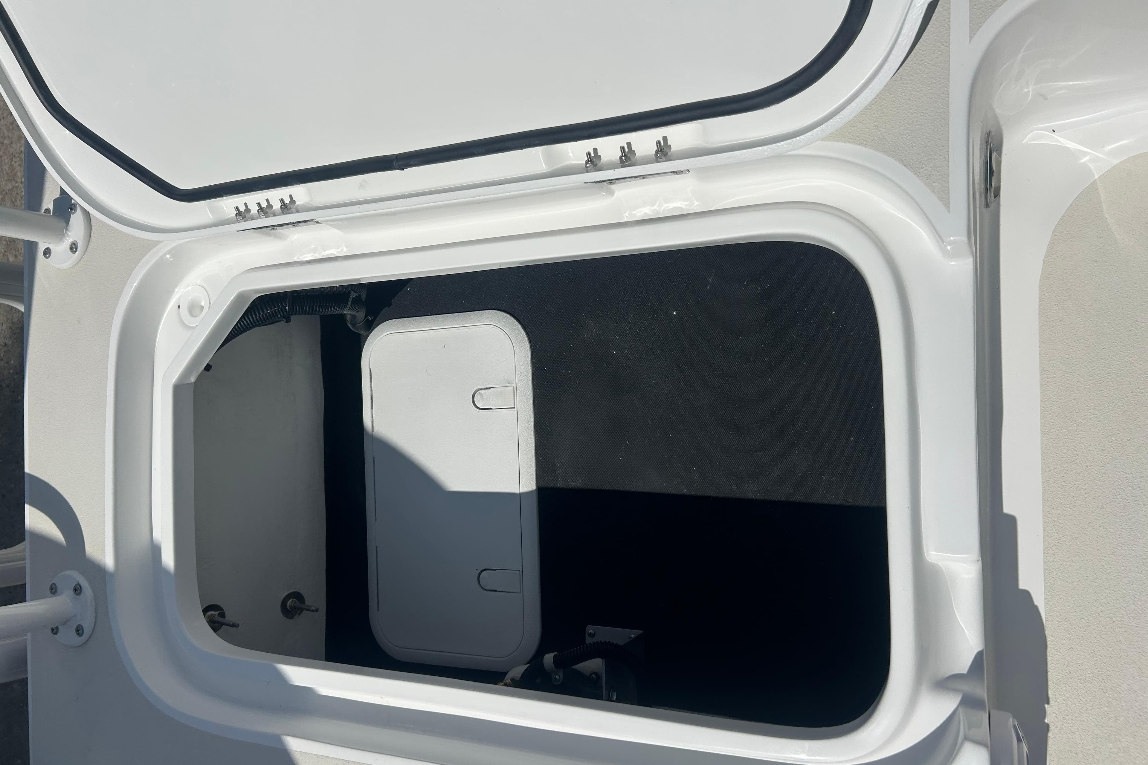 Open storage compartment on a 2026 Shallow Sport 25 X3 boat.