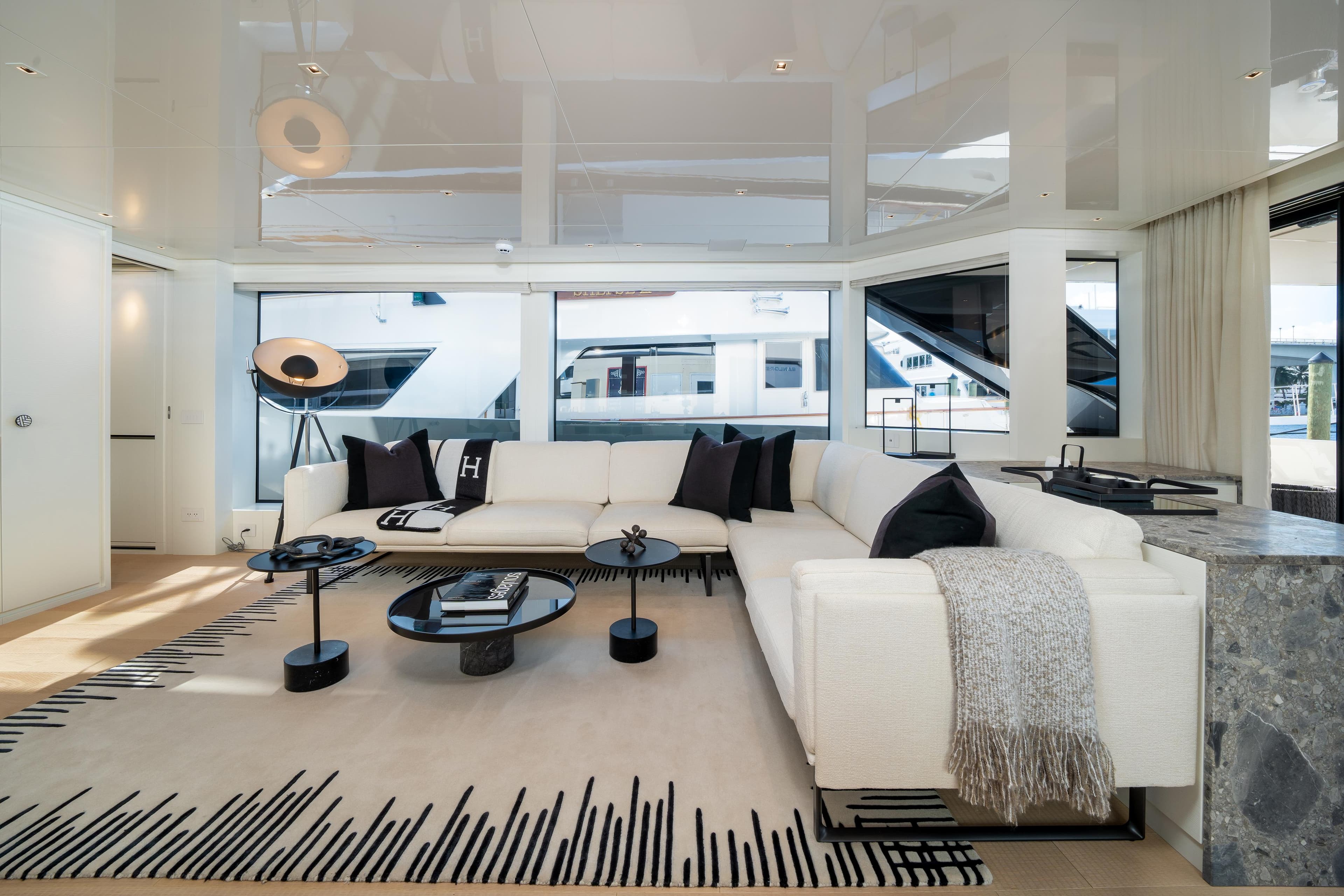 Luxurious interior of 2022 Sanlorenzo SL96A yacht with modern white sofa and elegant decor.