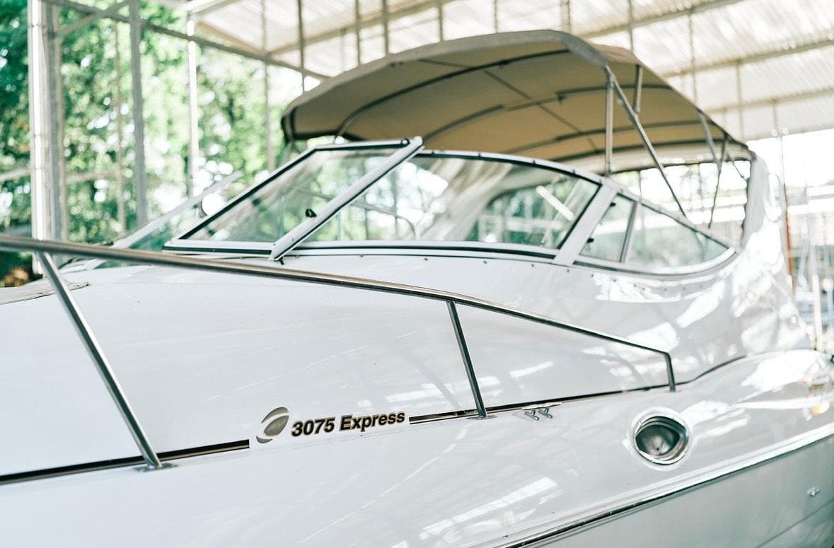 2001 Cruisers Yachts 3075 Express boat with canopy in a marina setting.