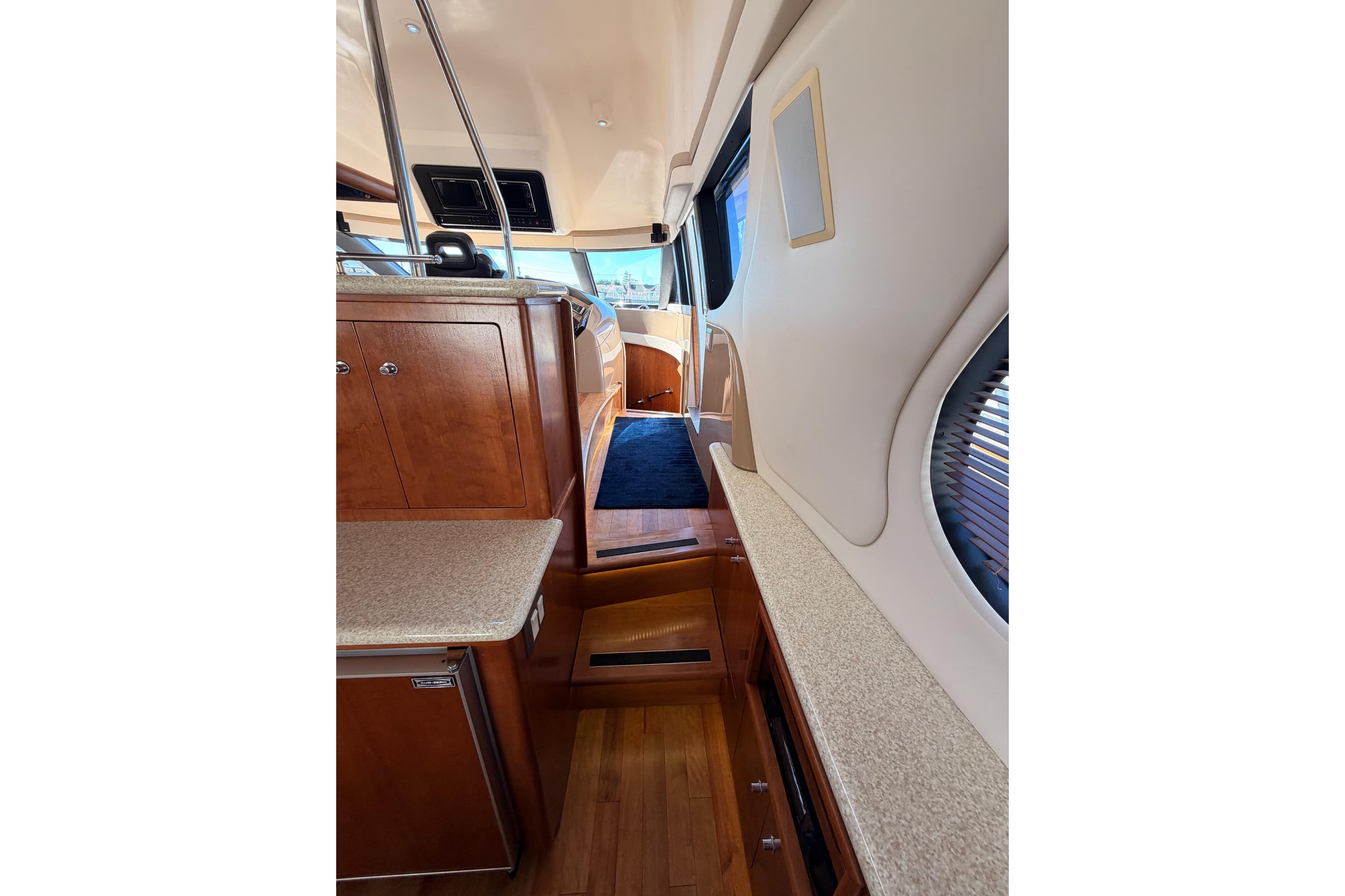 Interior of 1999 Carver 530 Voyager Pilothouse with wood cabinetry and blue carpet.