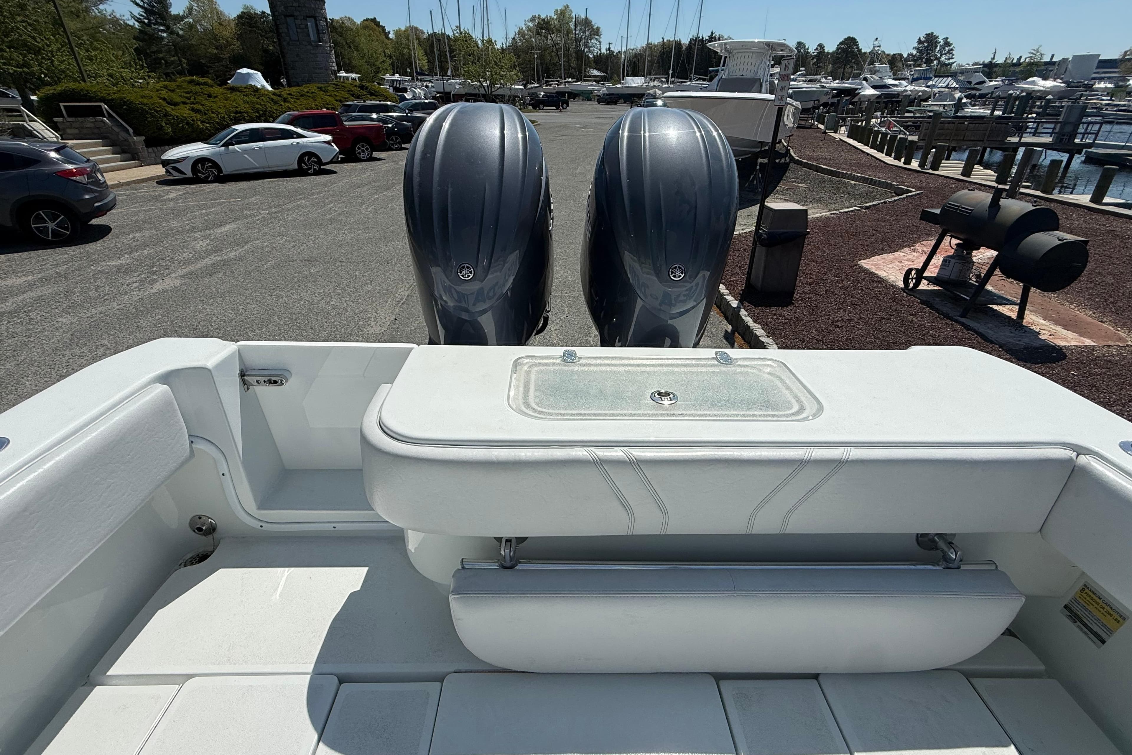 2024 Contender 25 Tournament boat with dual outboard engines at a marina.