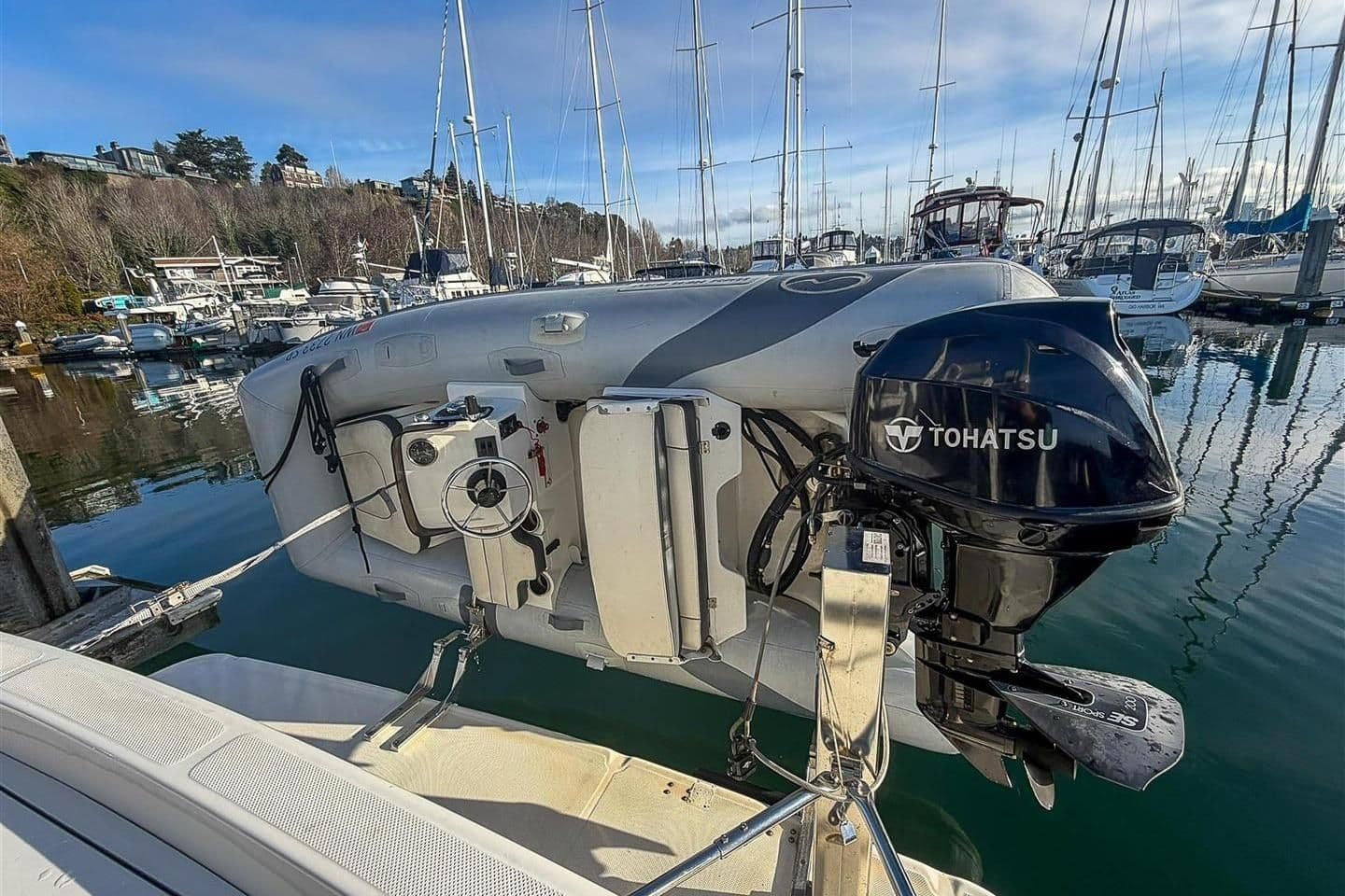 2002 Bayliner 3988 Command Bridge Motoryacht with Tohatsu outboard motor at marina.
