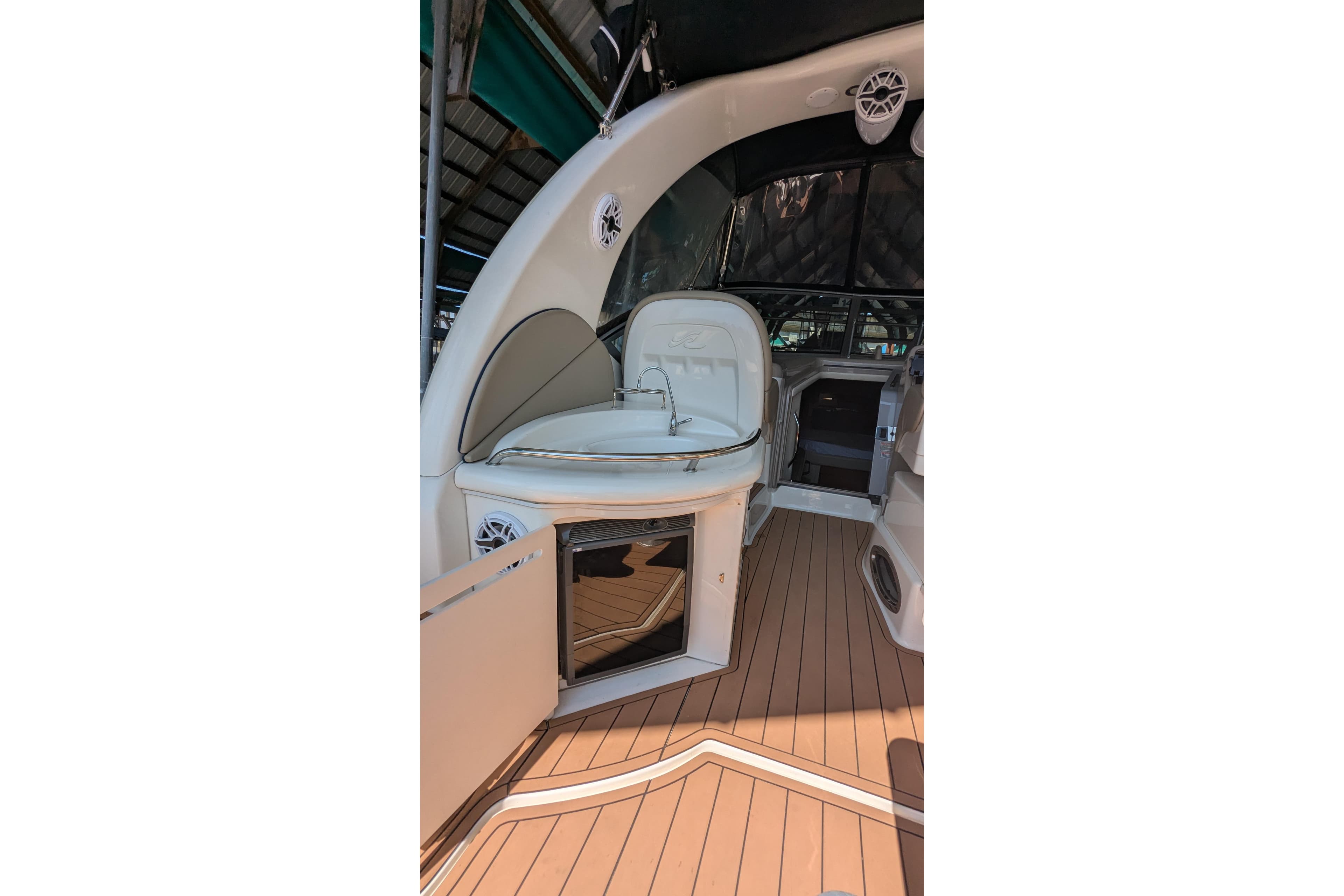 2004 Sea Ray 340 Sundancer interior with seating and wooden flooring.