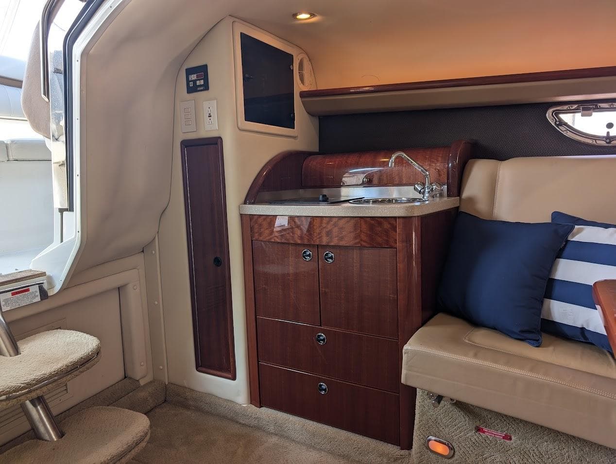 Luxurious interior of 2007 Cobalt 323 boat with kitchenette and seating area.