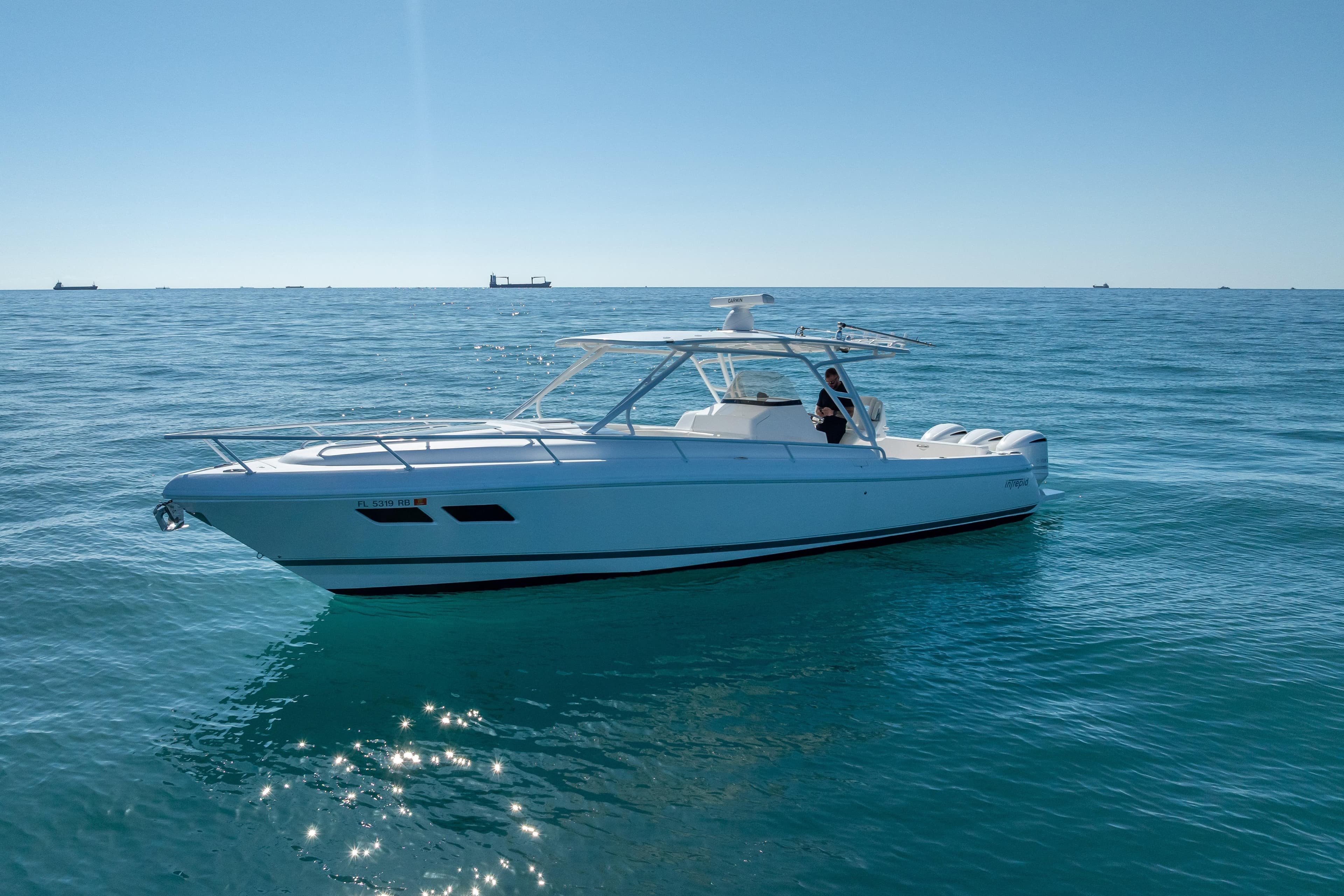 2016 Intrepid 375 Center Console boat on calm ocean waters under clear blue sky.