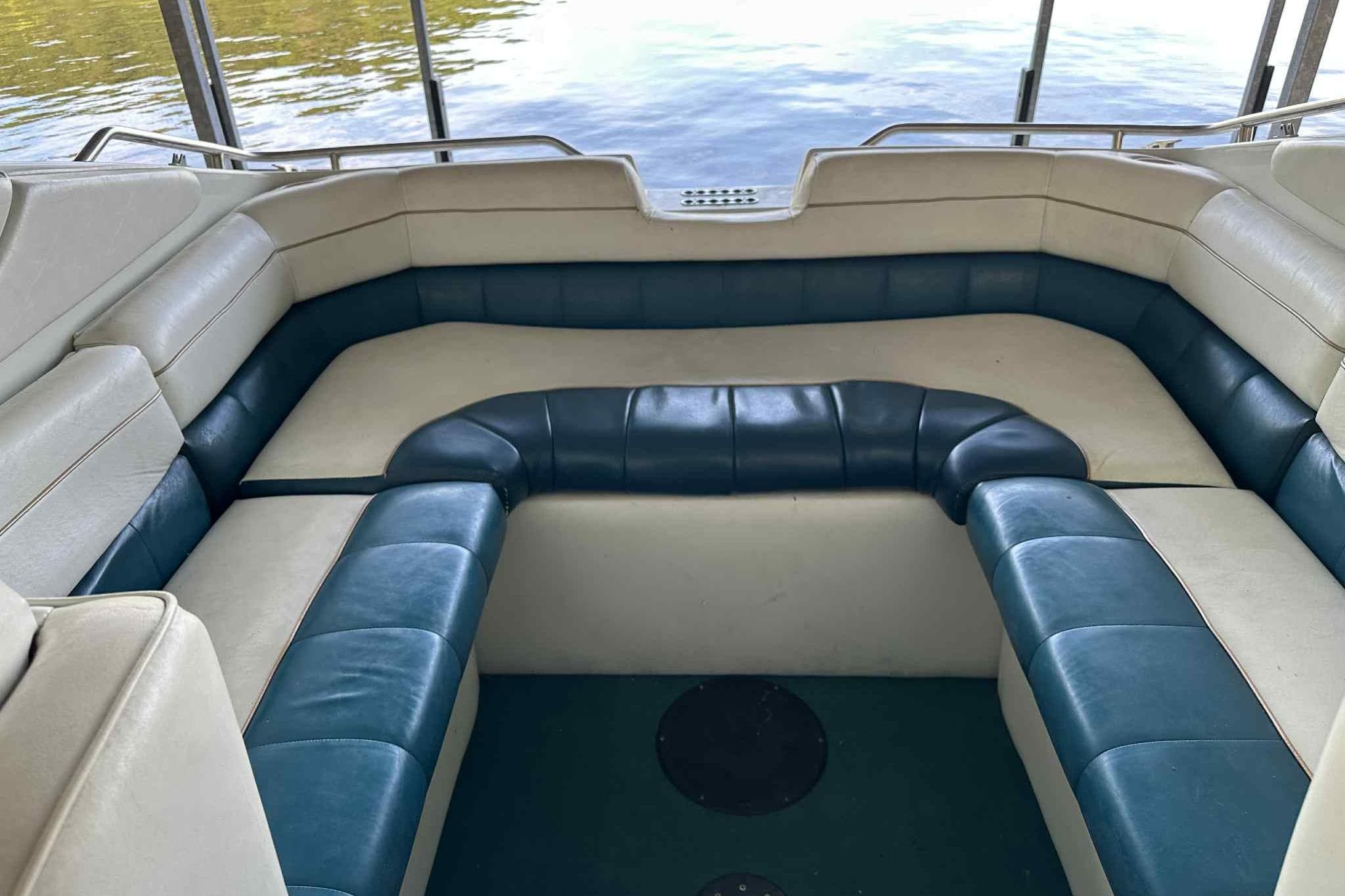 Interior seating of a 1995 Genesis Boats 2505, featuring blue and white upholstery.