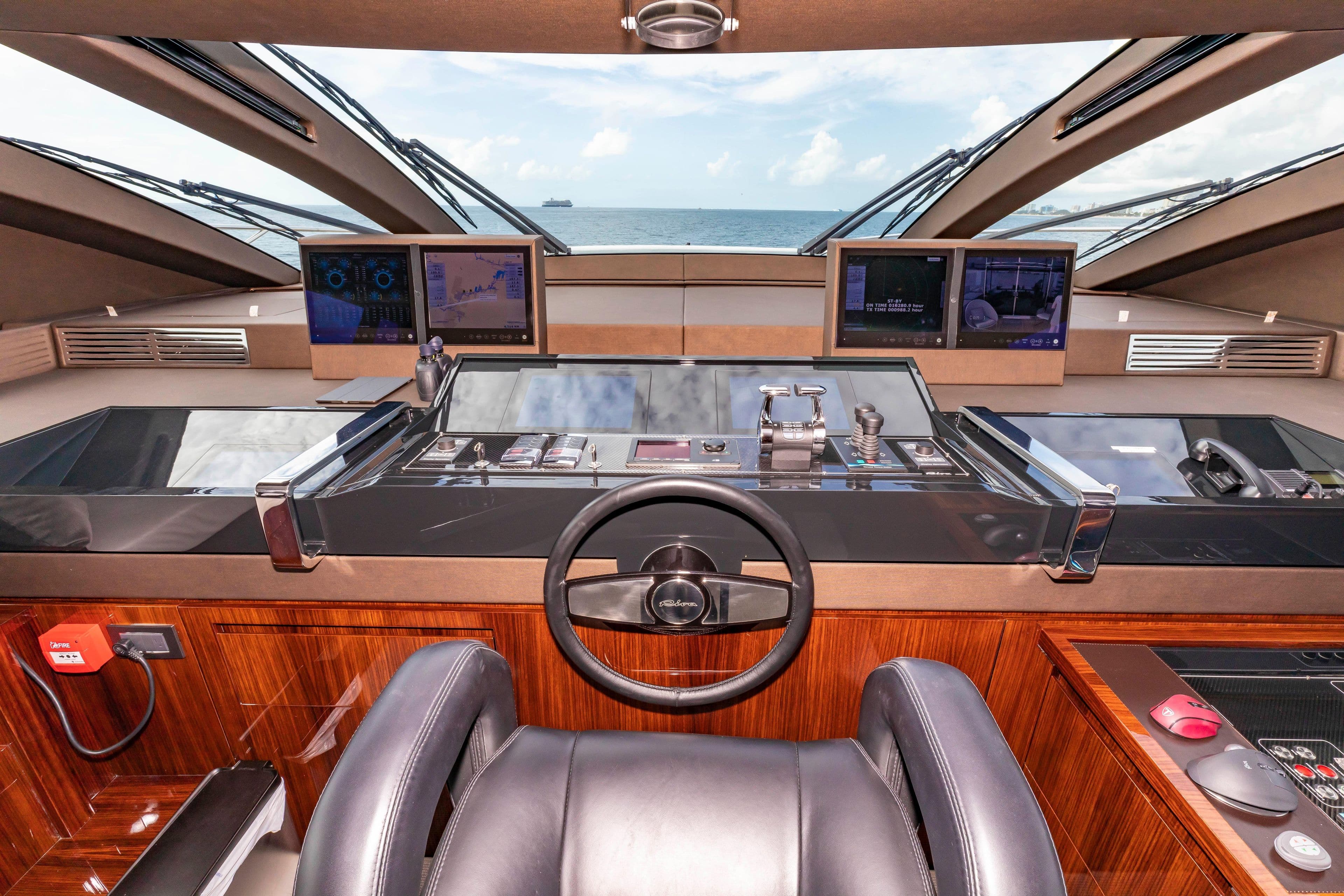 Cockpit of 2020 Riva 110' Dolcevita yacht with advanced navigation systems and ocean view.