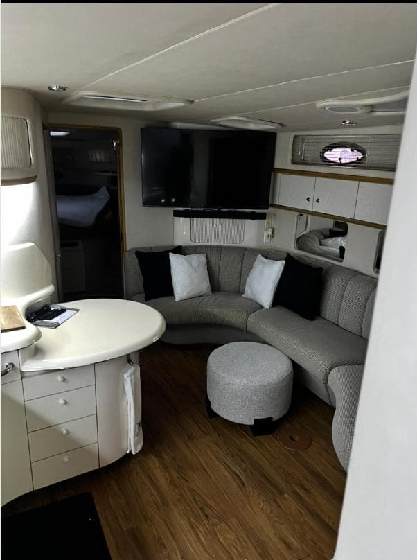 Interior of 1995 Sea Ray 450 Sundancer yacht with cozy seating and modern decor.