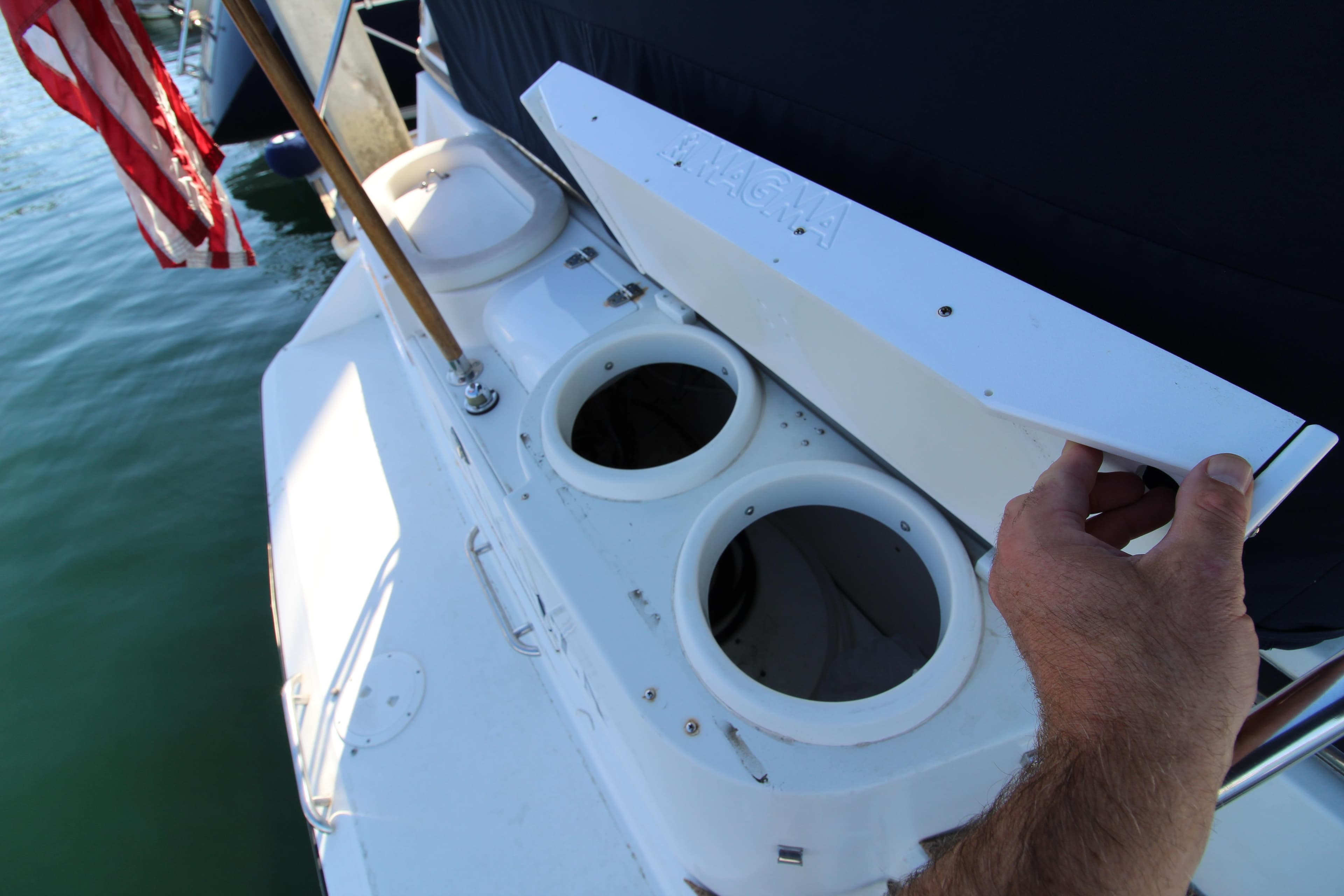 1990 Carver 3467 Santego boat with open storage compartments on deck.