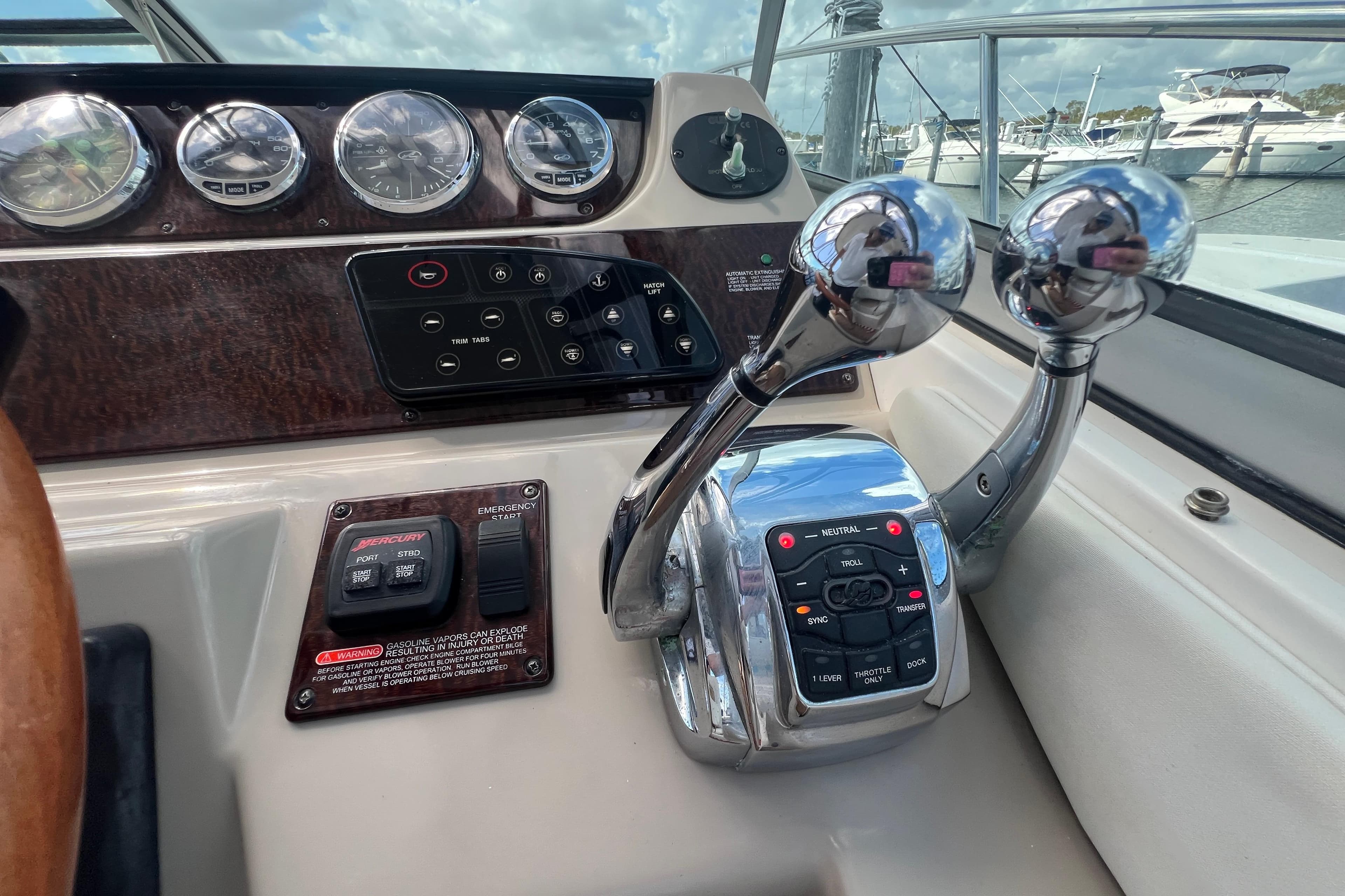 Control panel of a 2005 Sea Ray Sundancer 350 boat with throttle levers.