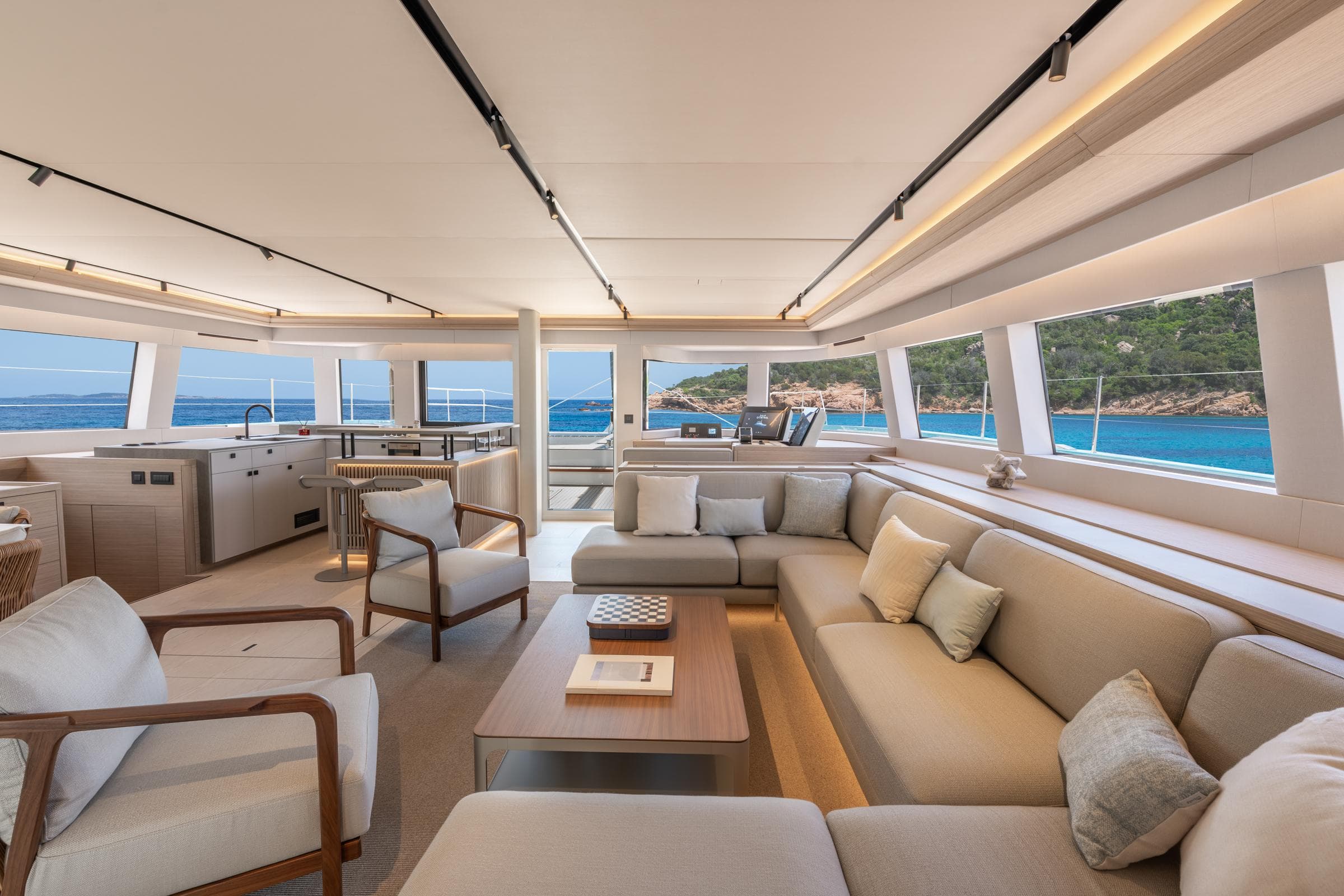 Luxurious interior of 2025 Lagoon Eighty 2 yacht with ocean view and modern furnishings.