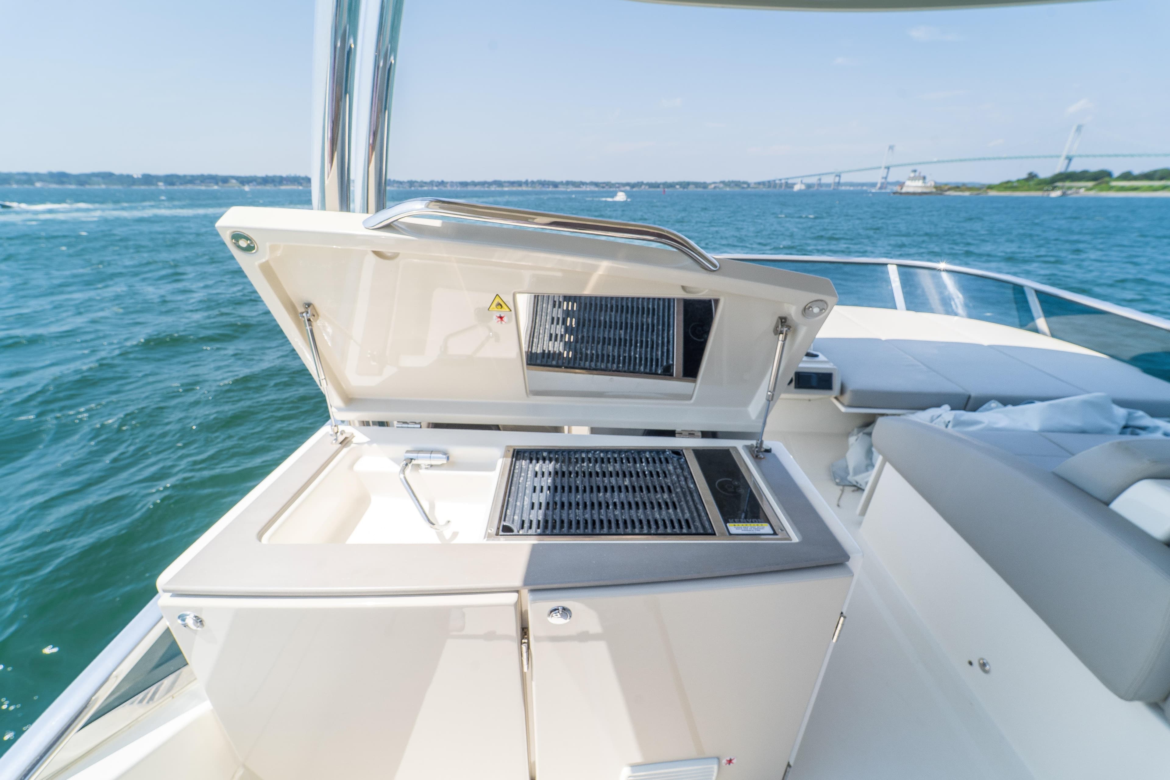 Luxury outdoor kitchen on 2023 Absolute 62 Fly yacht, with ocean view.
