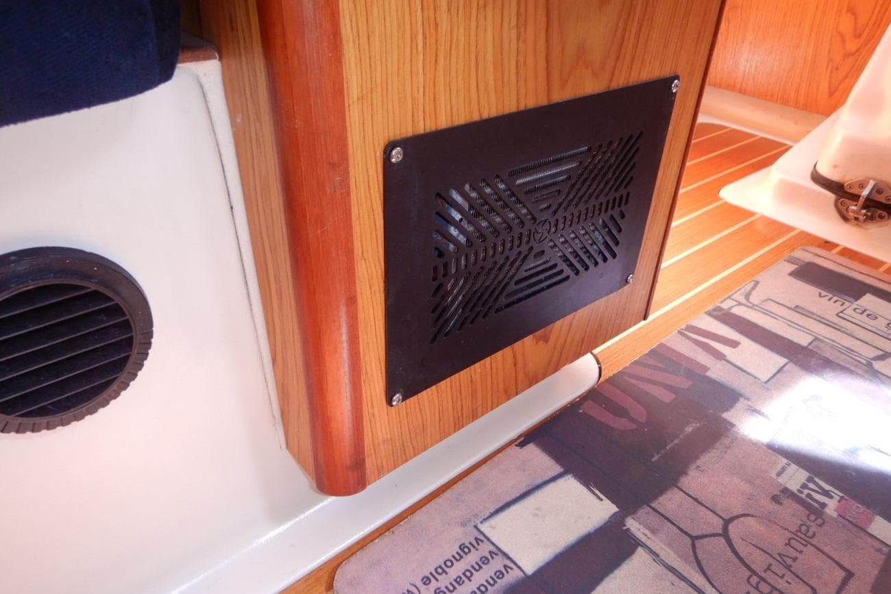 Interior of a 2001 Hunter 320 sailboat showing a vent and wooden paneling.