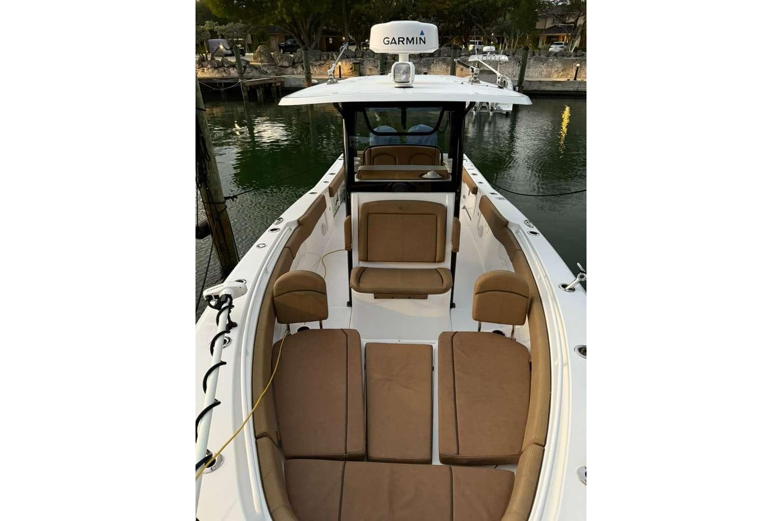 2021 Sea Hunt Gamefish 30 with forward seating, docked by the water.