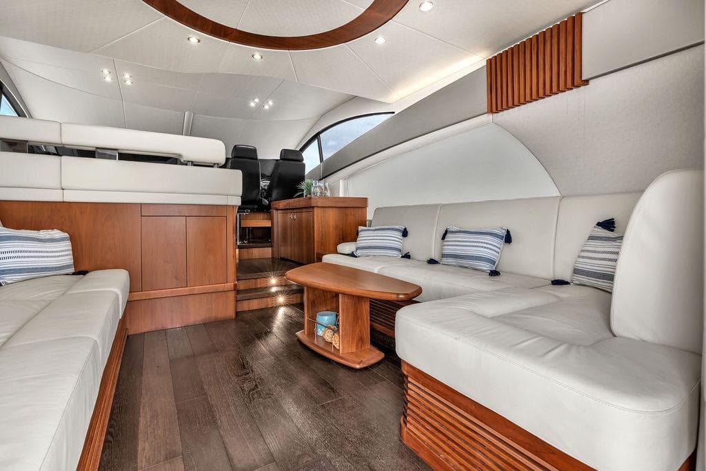Luxurious interior of 2016 Sunseeker Manhattan 55 yacht with elegant seating and wooden accents.