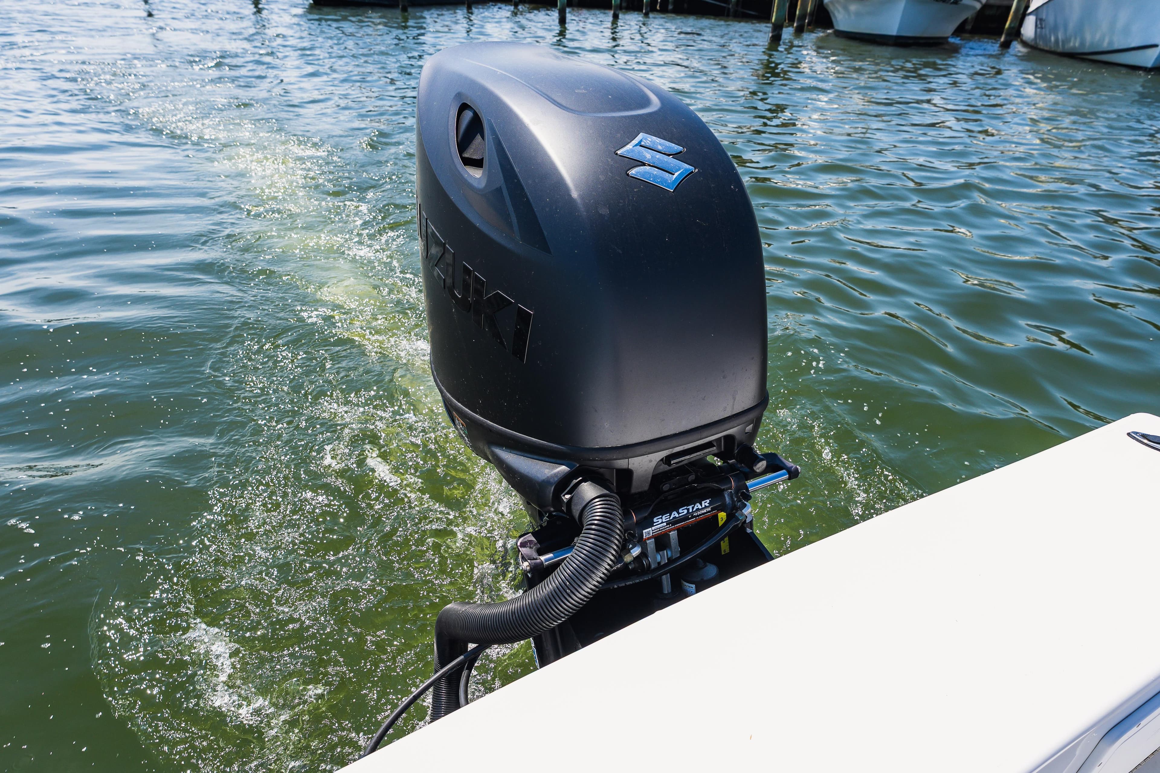 Outboard motor on a 1979 Privateer 20 boat cruising through water.