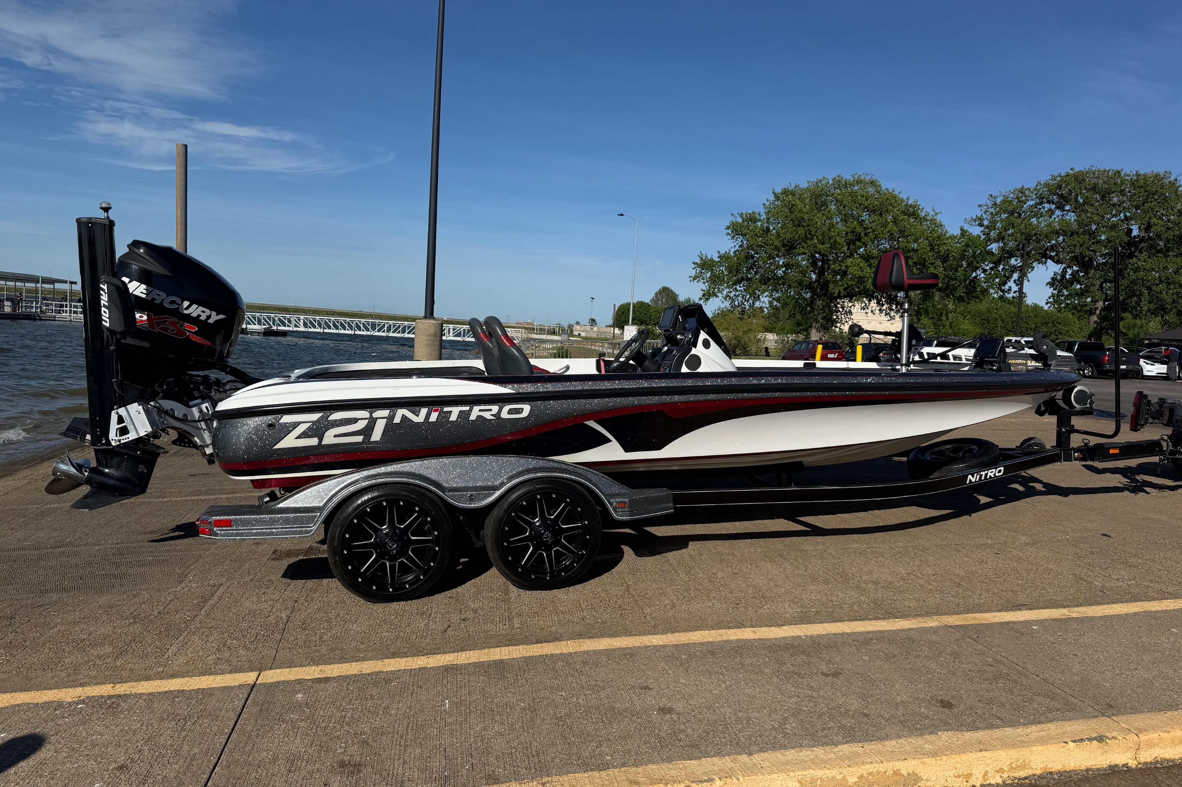 2016 Nitro Z21 boat on trailer by the water, featuring a Mercury engine.