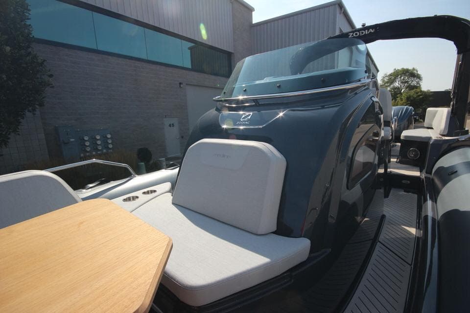 2024 Zodiac MEDLINE 9 NEO boat with seating and table, docked outdoors.