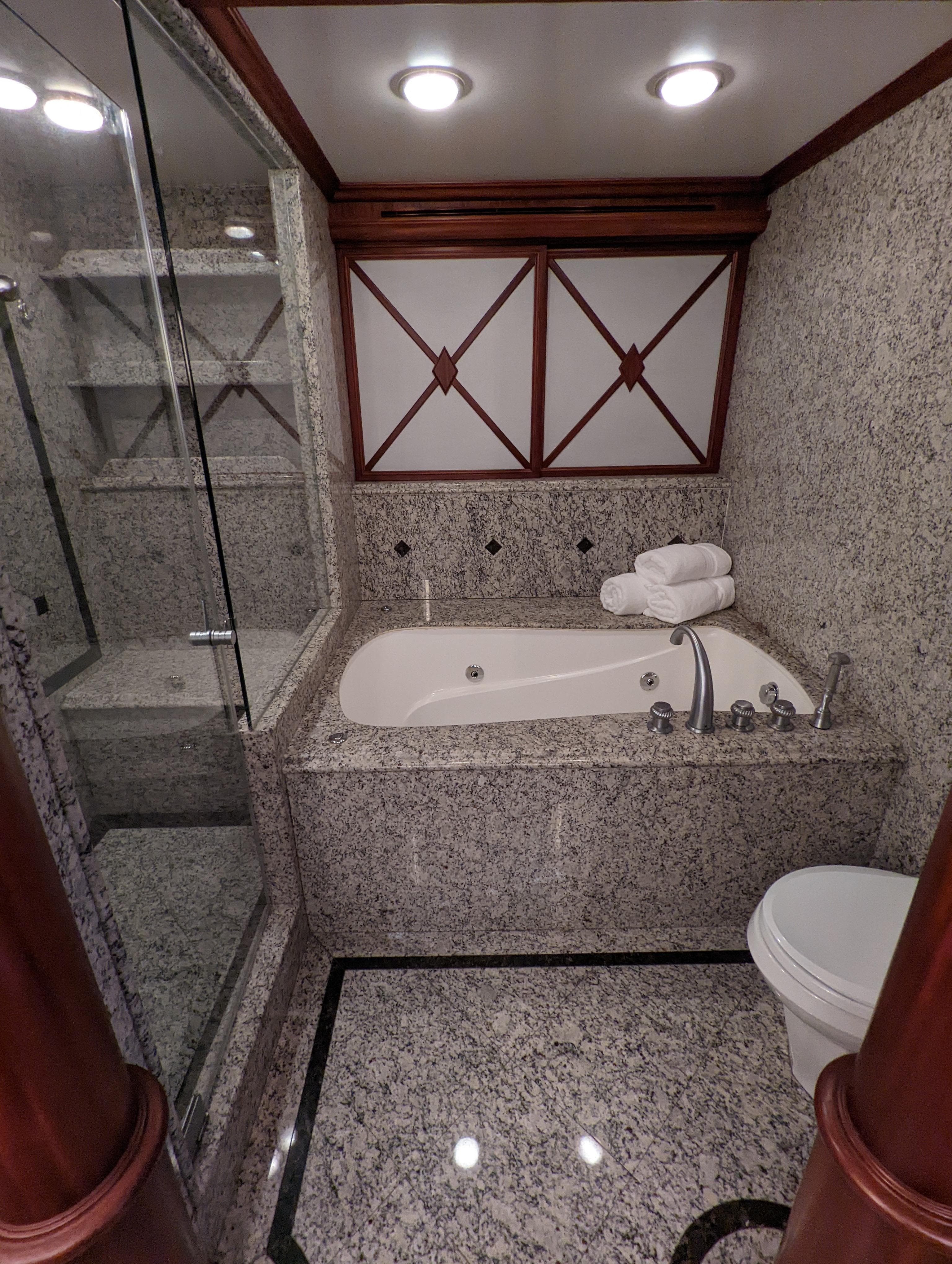Luxurious bathroom in 2006 Cheoy Lee Motor Yacht Bravo Series with granite finishes.