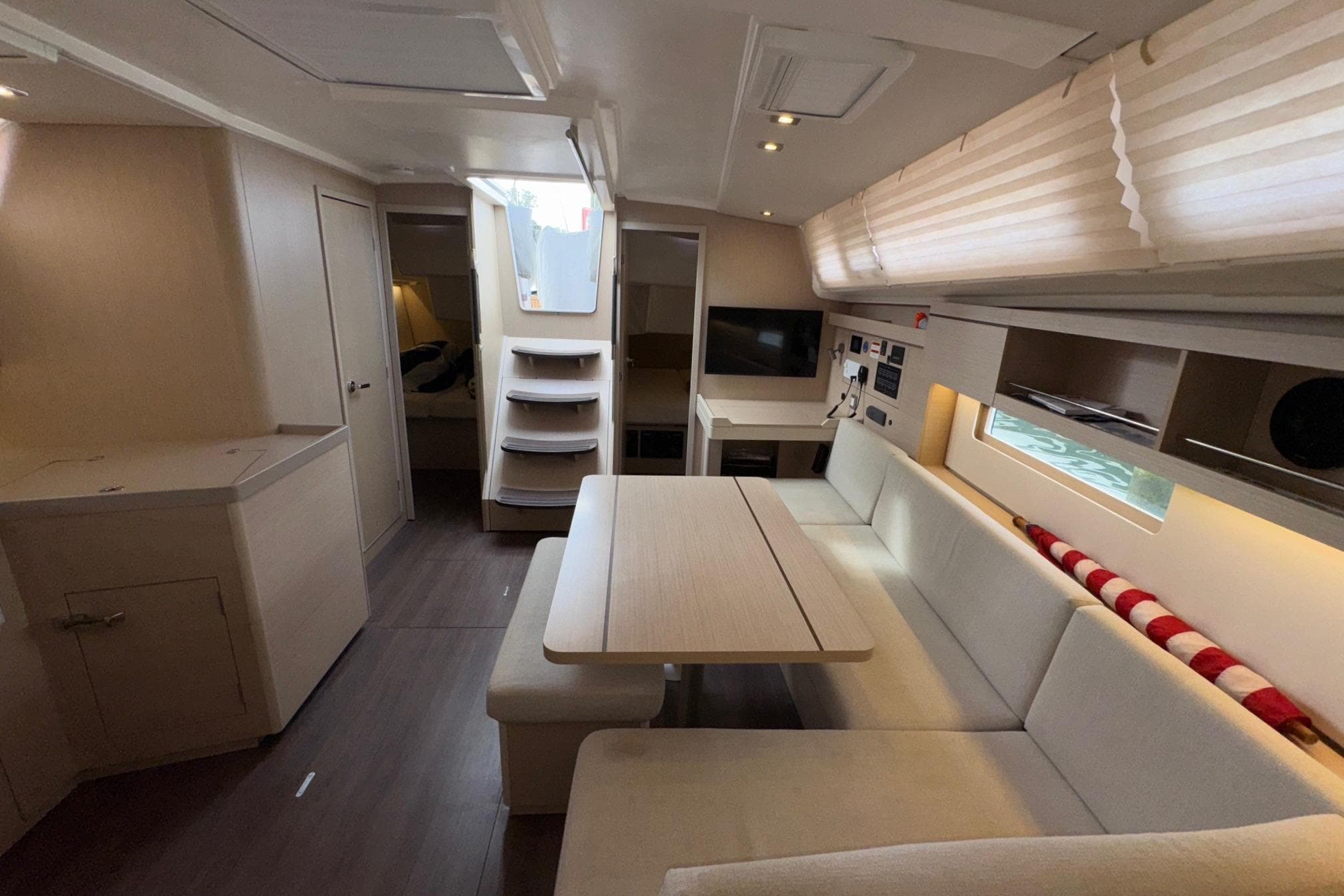 Interior of 2022 Beneteau Oceanis 40.1 yacht, featuring modern seating and dining area.