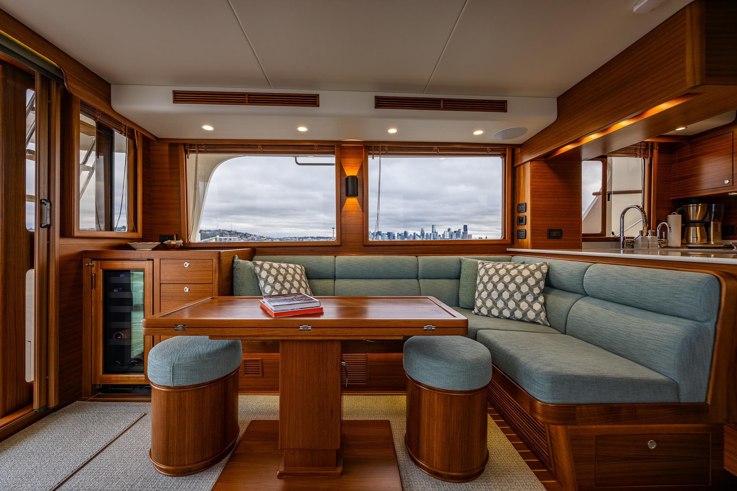 Luxurious interior of 2026 Fleming 55 Pilothouse yacht with elegant wood and blue upholstery.