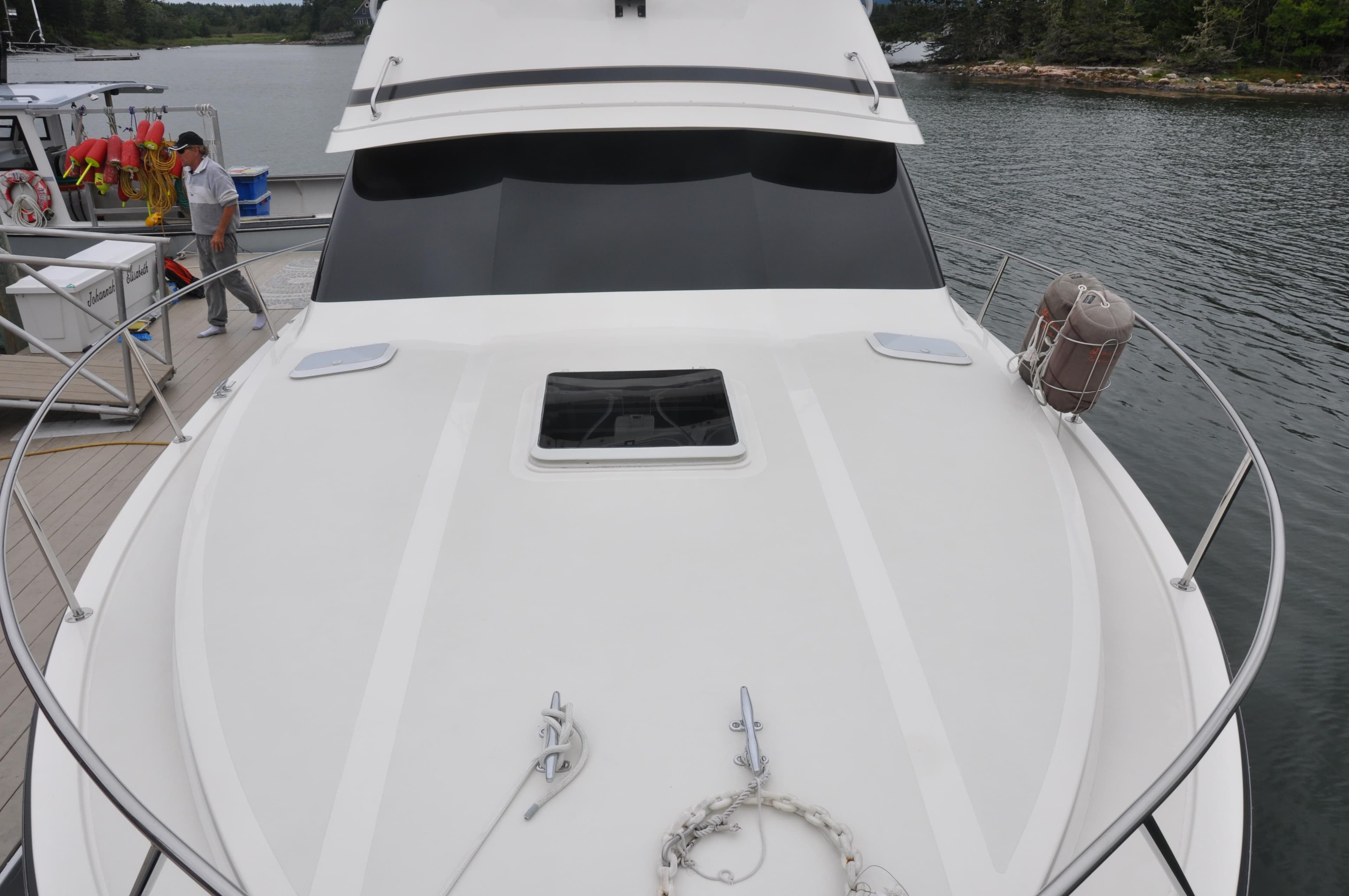 1987 Bertram 37 Convertible yacht docked at a marina.