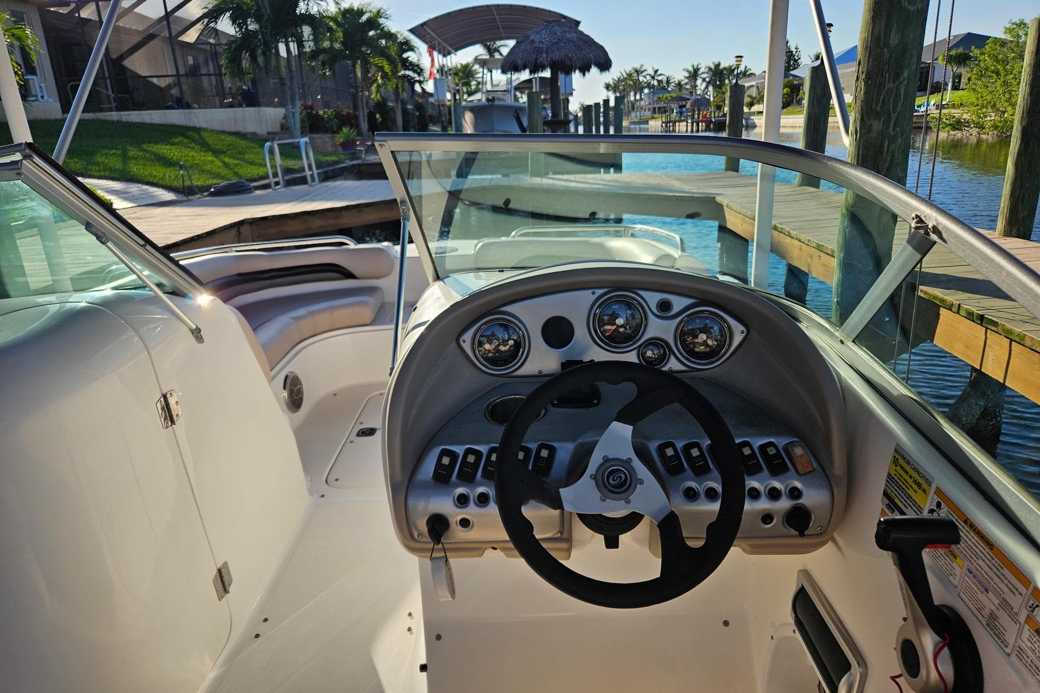 2013 Hurricane SunDeck 217 OB boat interior with steering wheel and dashboard controls.