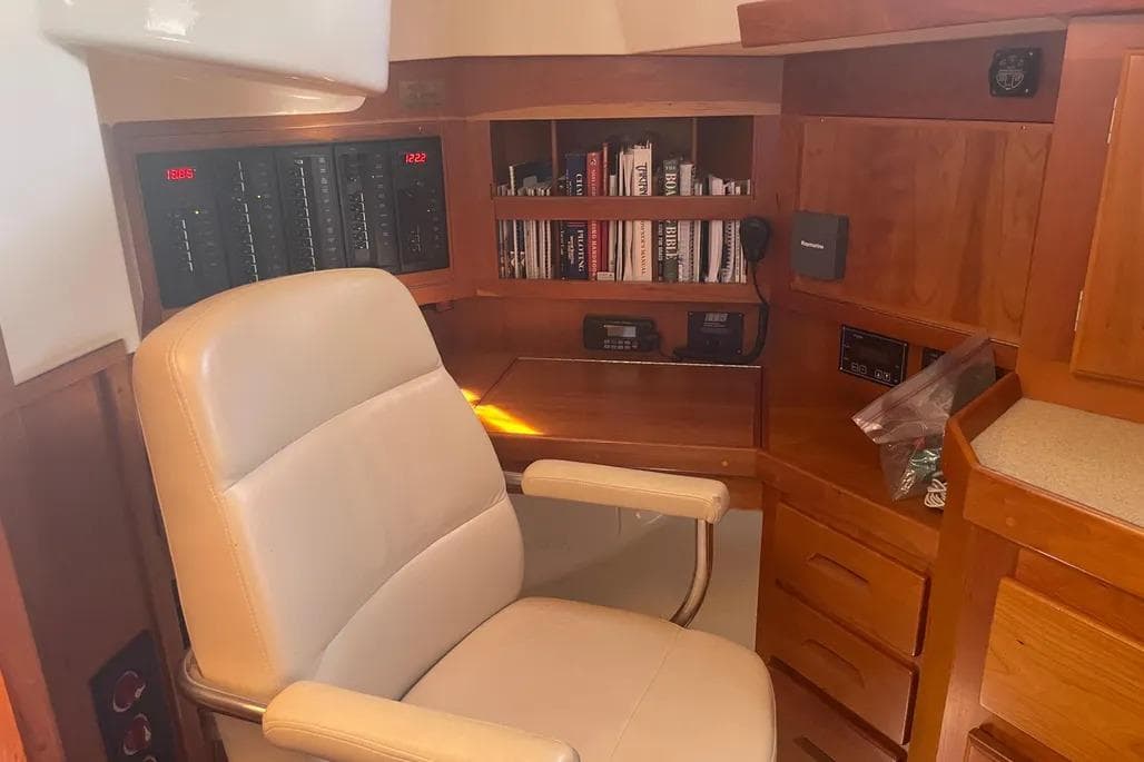 Luxurious Tartan 4300 yacht interior with leather chair and wooden cabinetry, 2009 model.