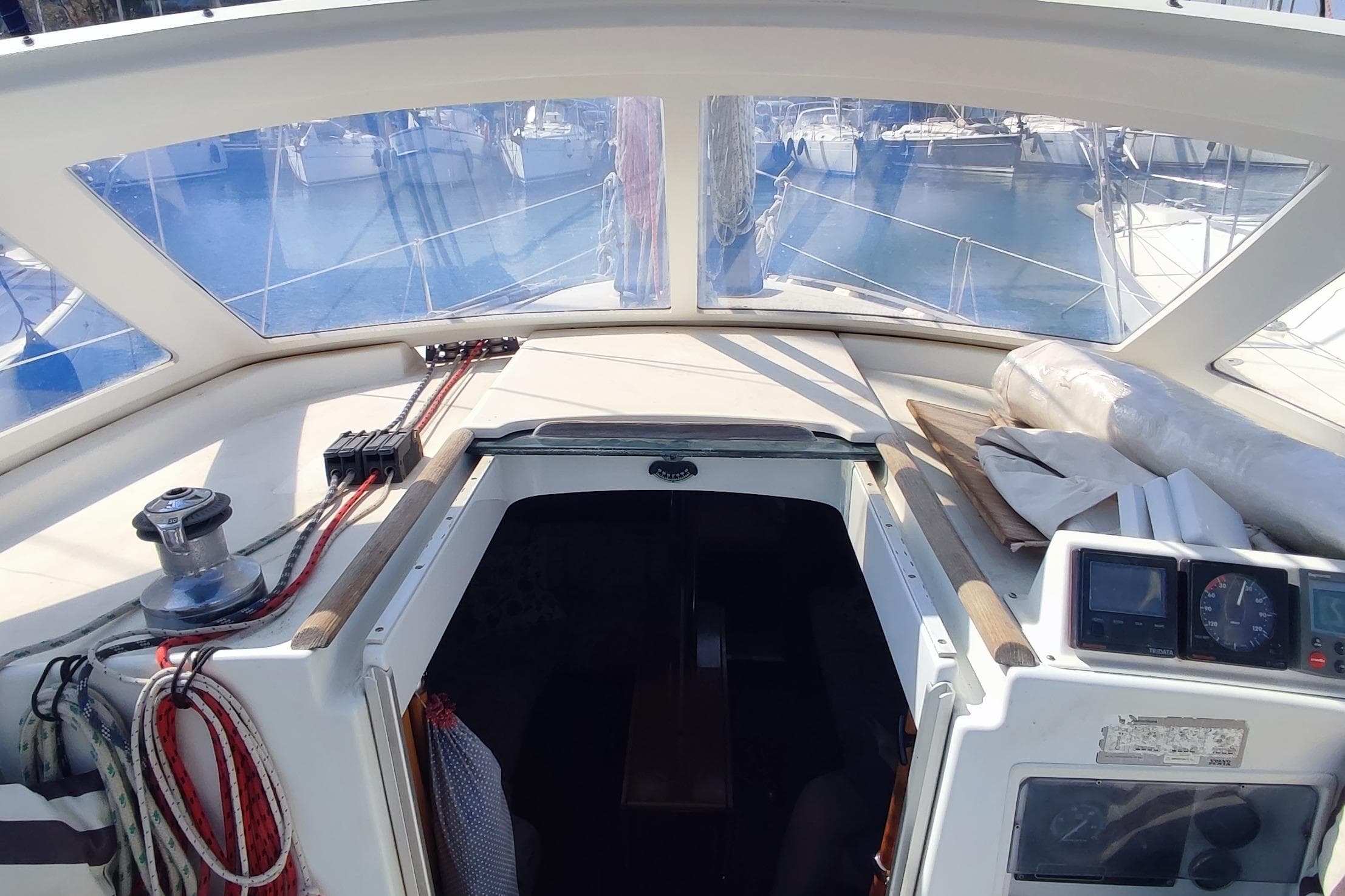 Cockpit view of a 1997 Beneteau Oceanis 36 CC sailboat in a marina.