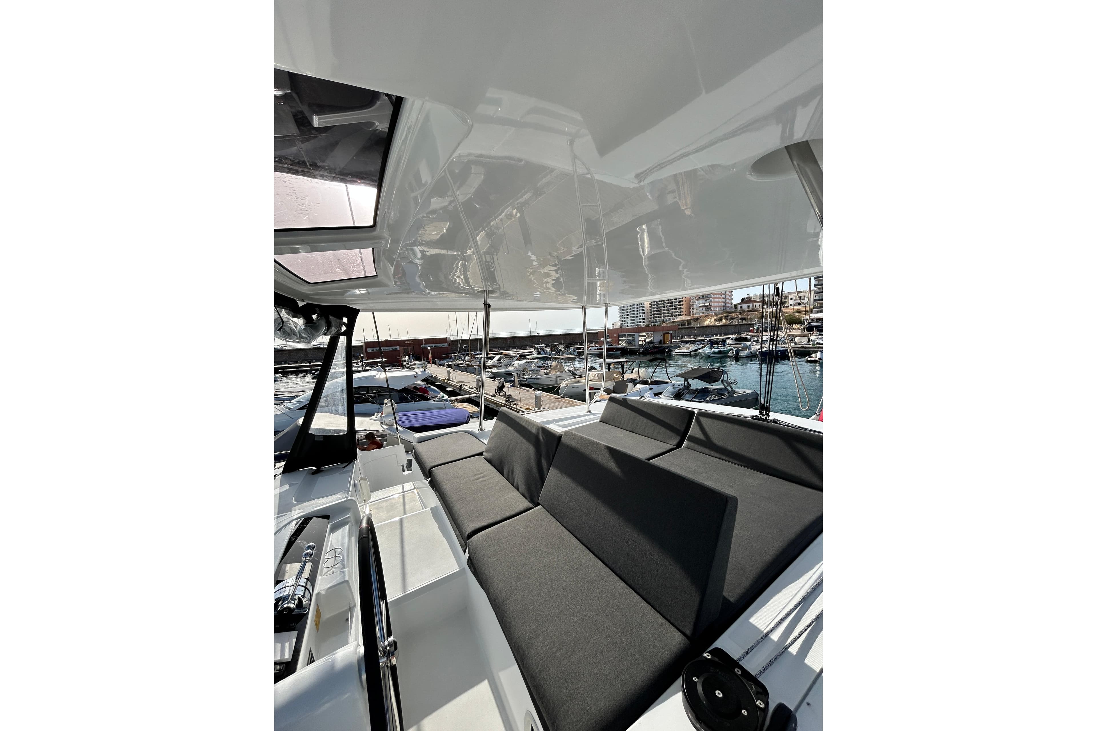 2024 Lagoon 46 yacht interior with sleek seating and marina view.