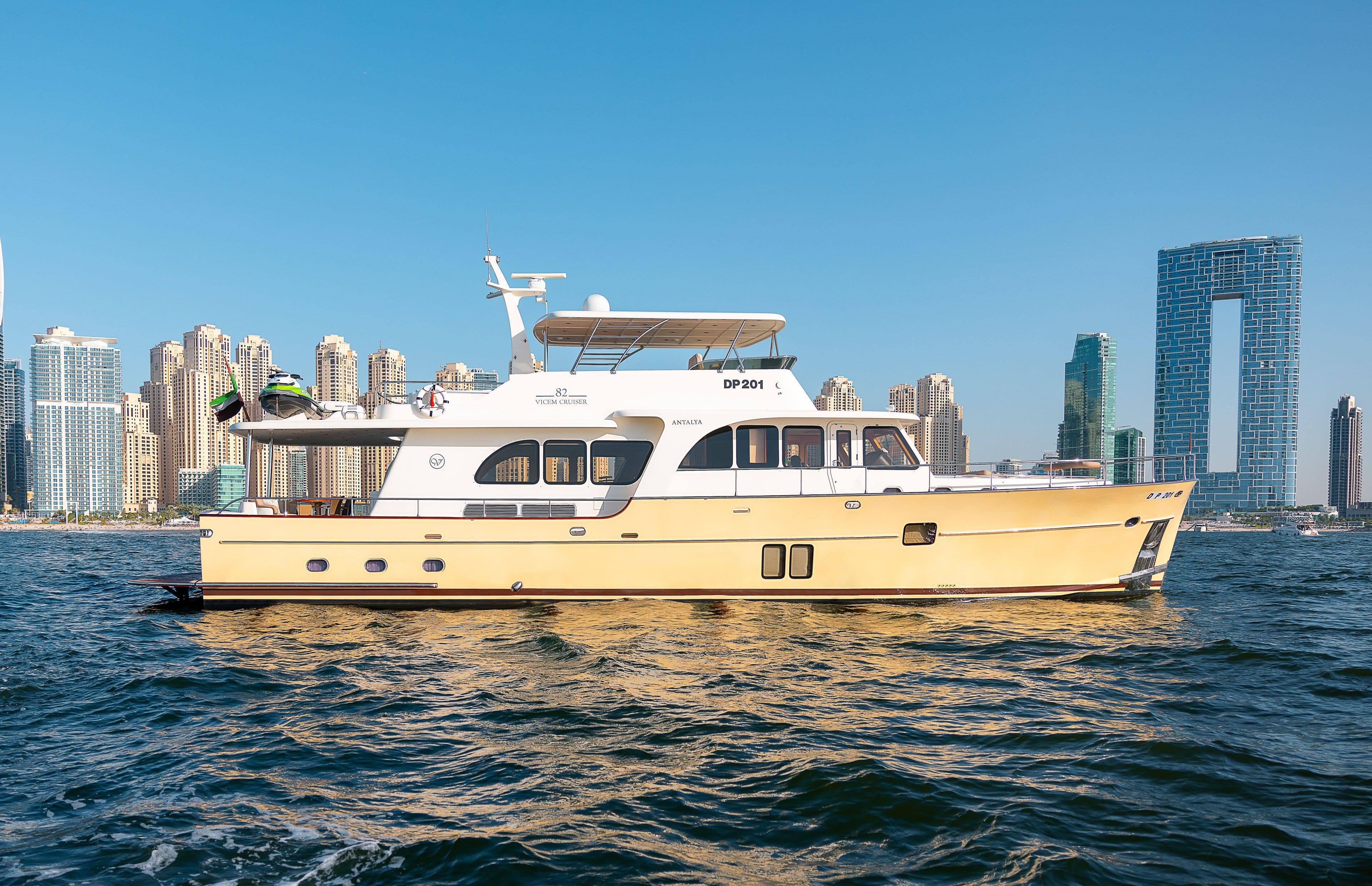 2011 Vicem Cruiser 78 yacht on water with city skyline background.
