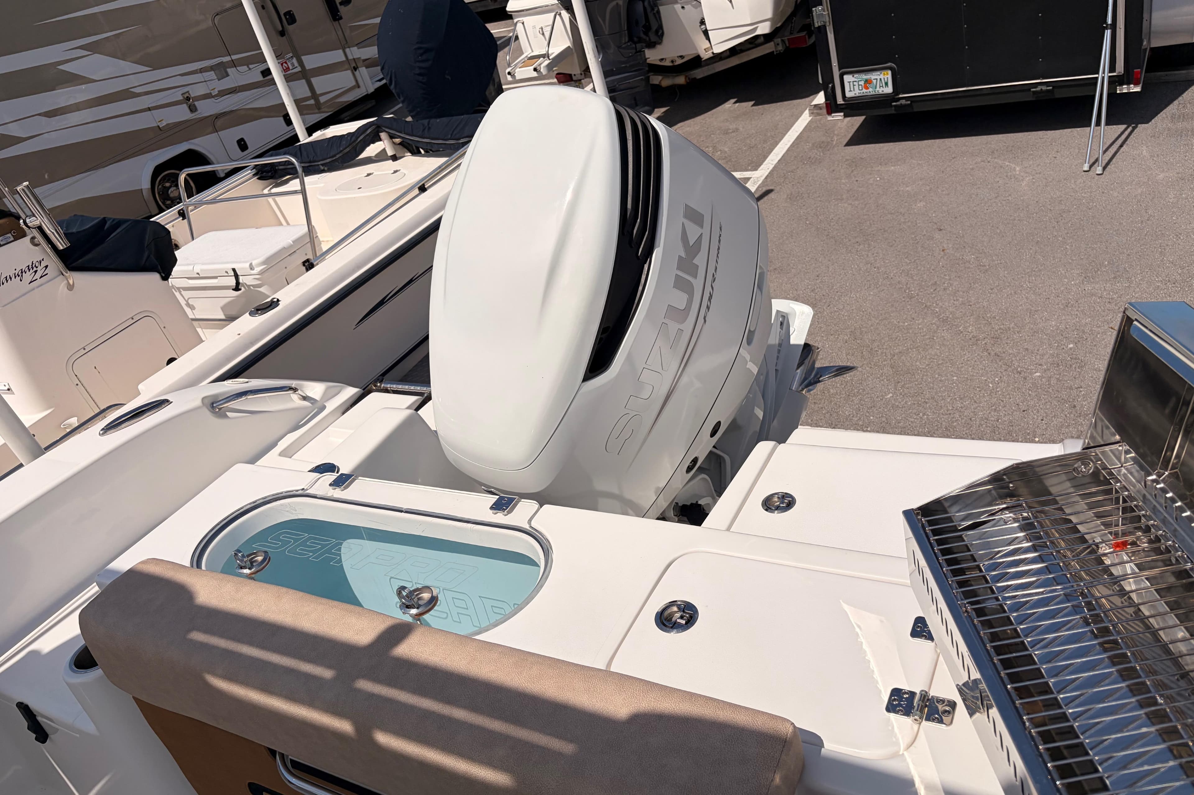 2025 Sea Pro 240 Dual Console boat with Suzuki outboard motor in a marina setting.