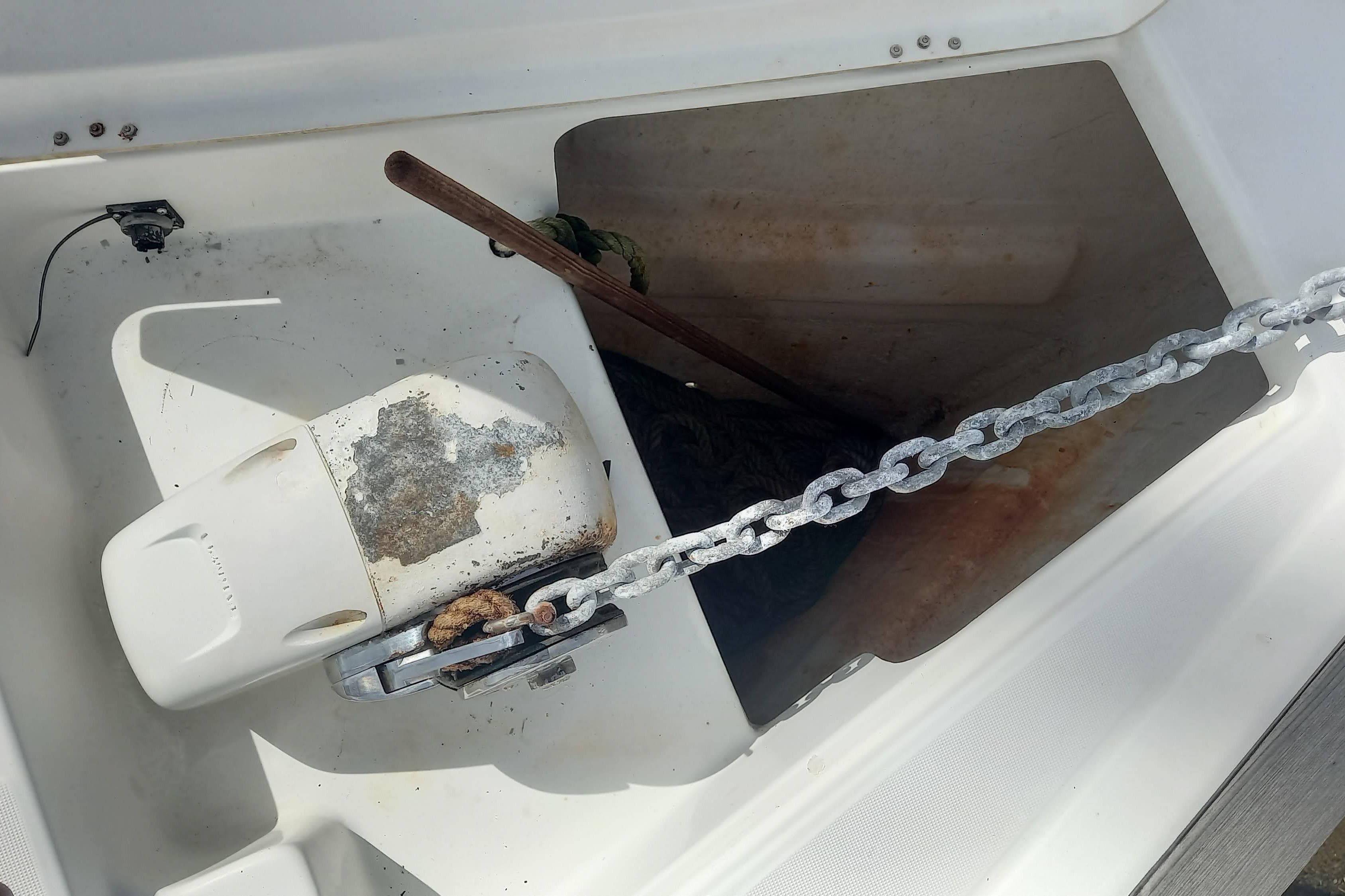 Anchor chain and windlass on a 2007 Beneteau 423 sailboat deck.