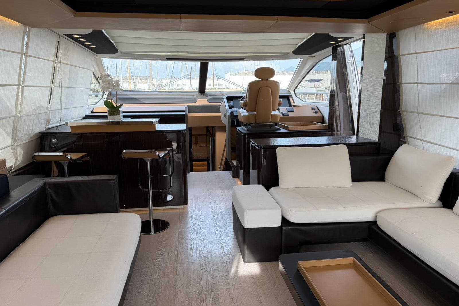 Luxurious interior of a 2016 Azimut 77S yacht with modern seating and helm.