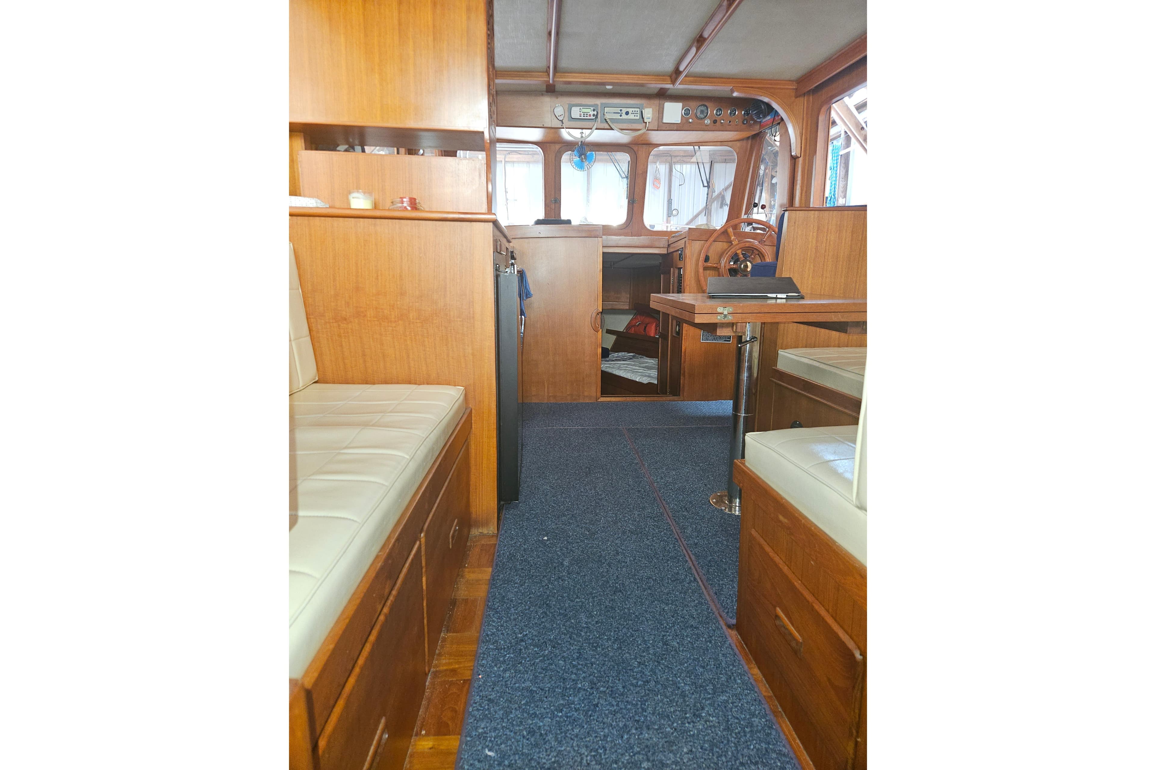 Interior of a 1978 CHB 34 boat with wooden furnishings and seating area.