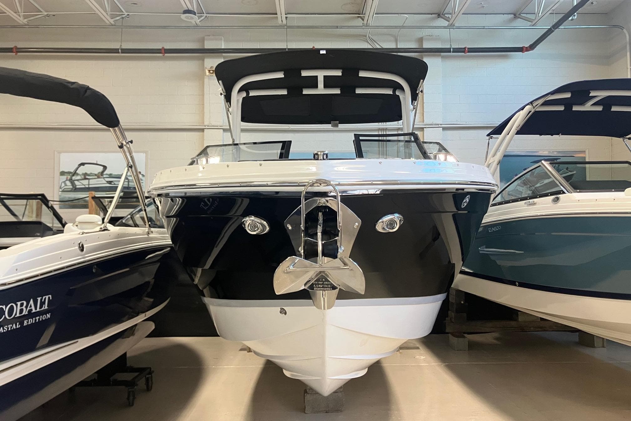 2026 Cobalt R6 boat displayed indoors, flanked by other boats.