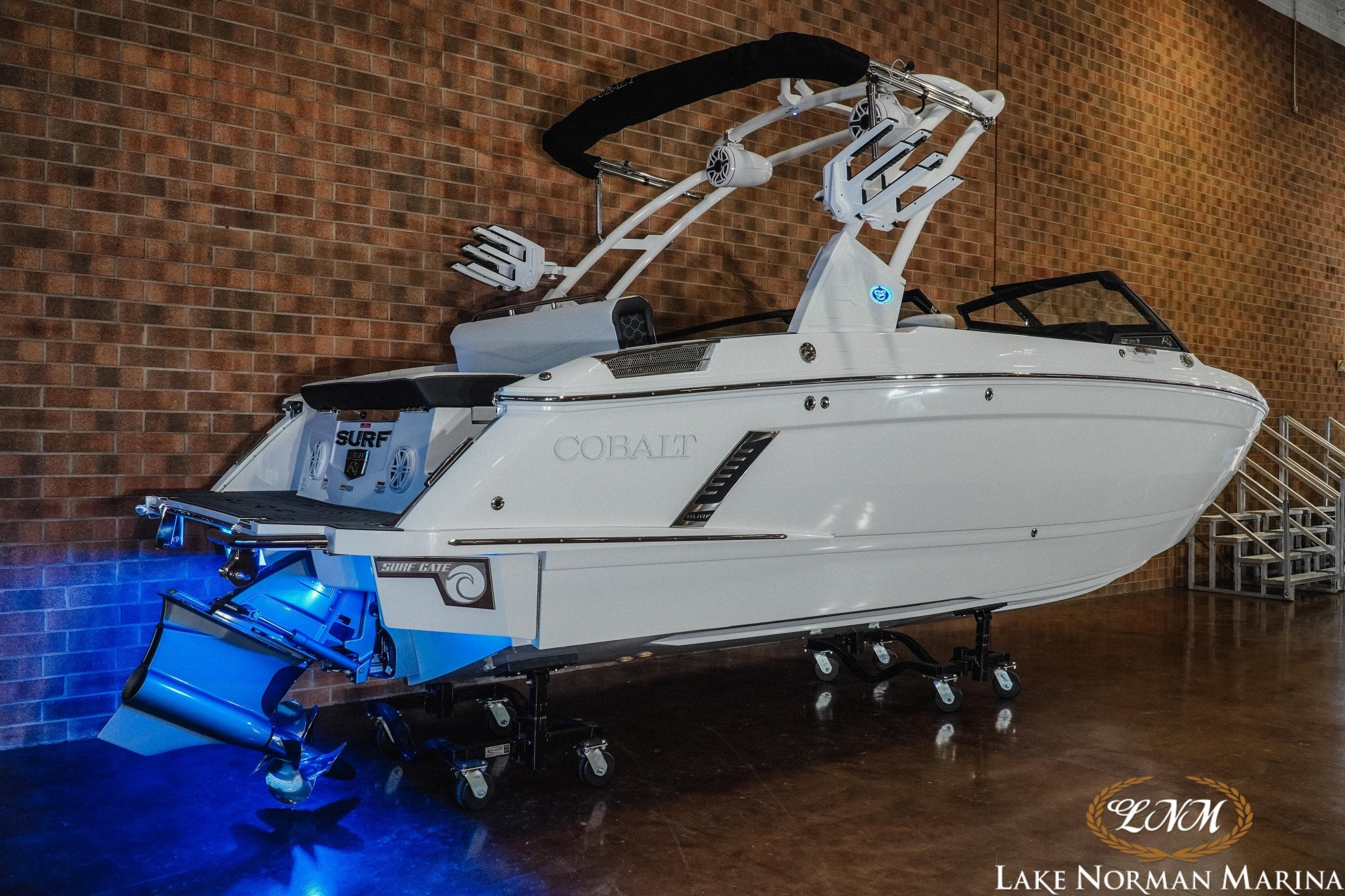 2026 Cobalt R4 Surf boat displayed indoors with blue lighting at Lake Norman Marina.