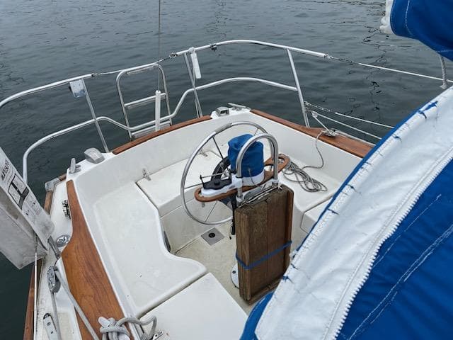 Cockpit of 1982 Sabre 30 MK I sailboat with wooden accents and steering wheel.