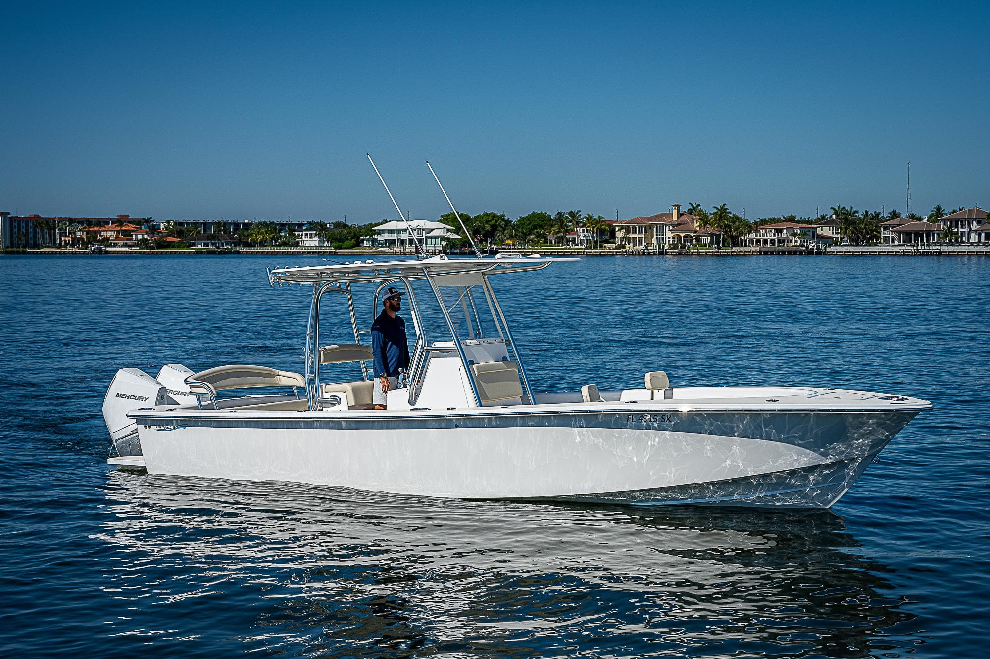 2020 Birdsall 30 CC boat on calm water, clear sky, waterfront homes in background.