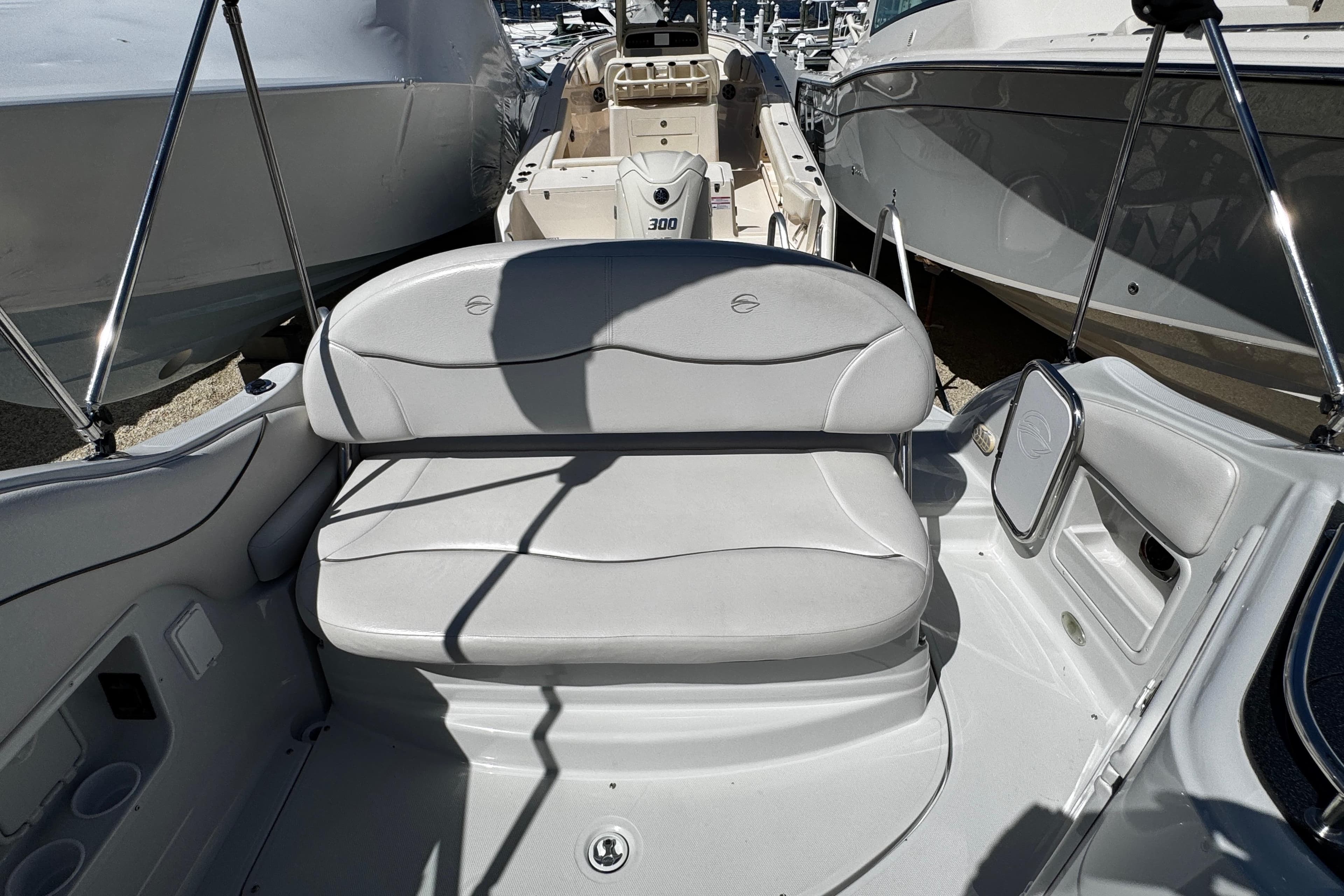 2004 Crownline 250 CR boat interior with gray seating and storage compartments.