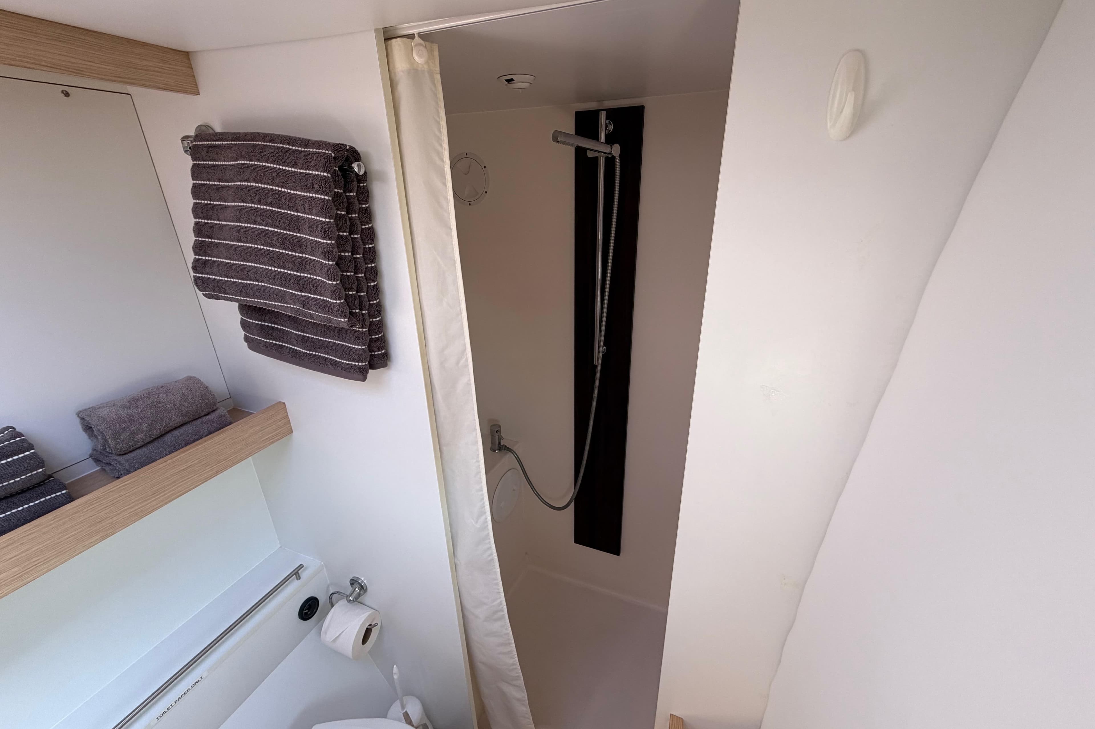 Bathroom interior of 2014 Outremer 45 yacht with shower and towels.
