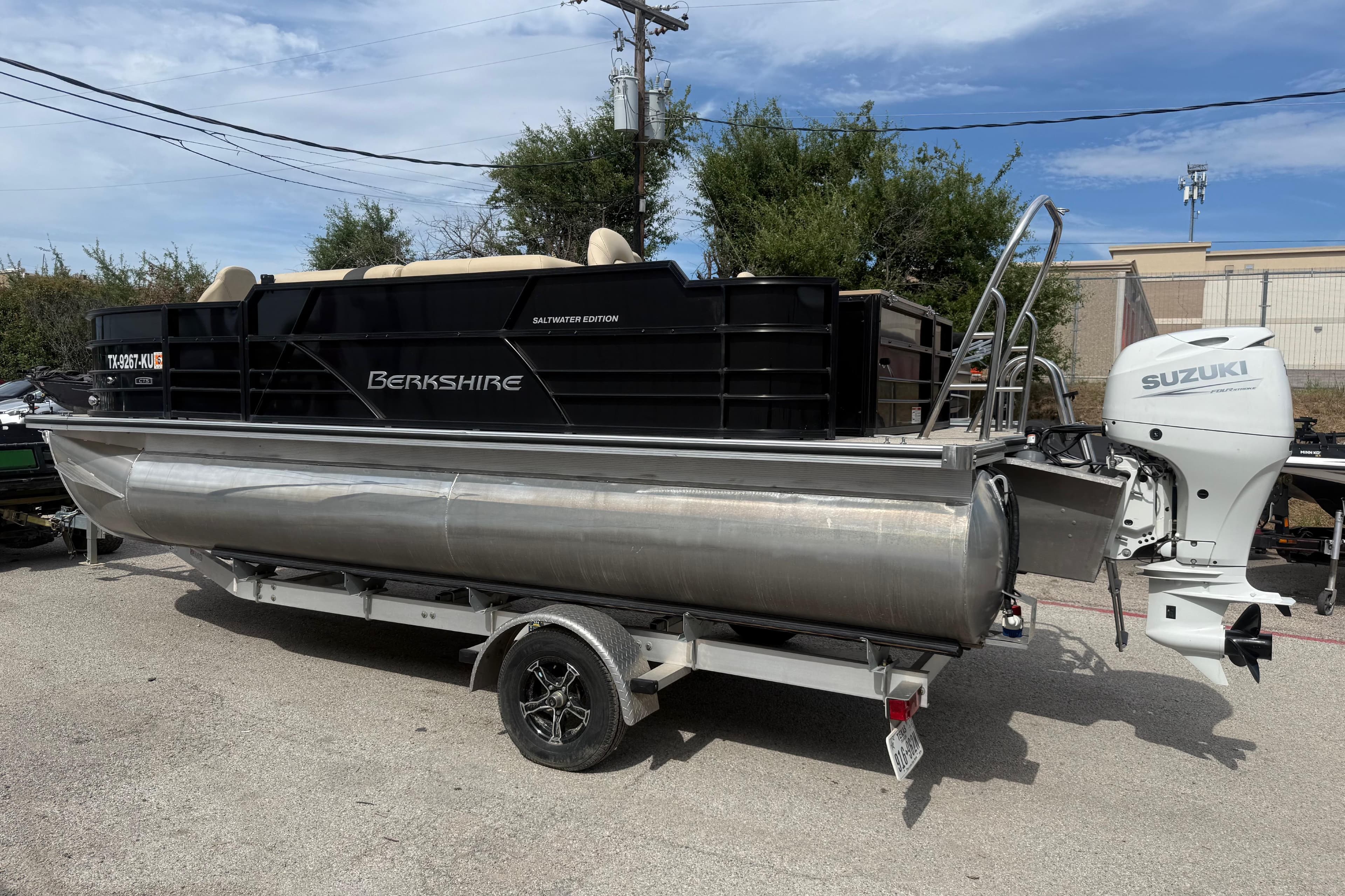 2023 Berkshire 20A CTS pontoon boat with Suzuki outboard motor on trailer.