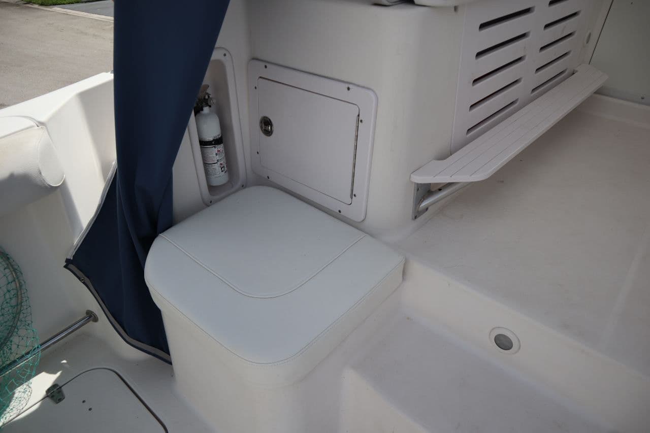 Interior of a 2007 Pro-Line 32 Express boat with seat and fire extinguisher.