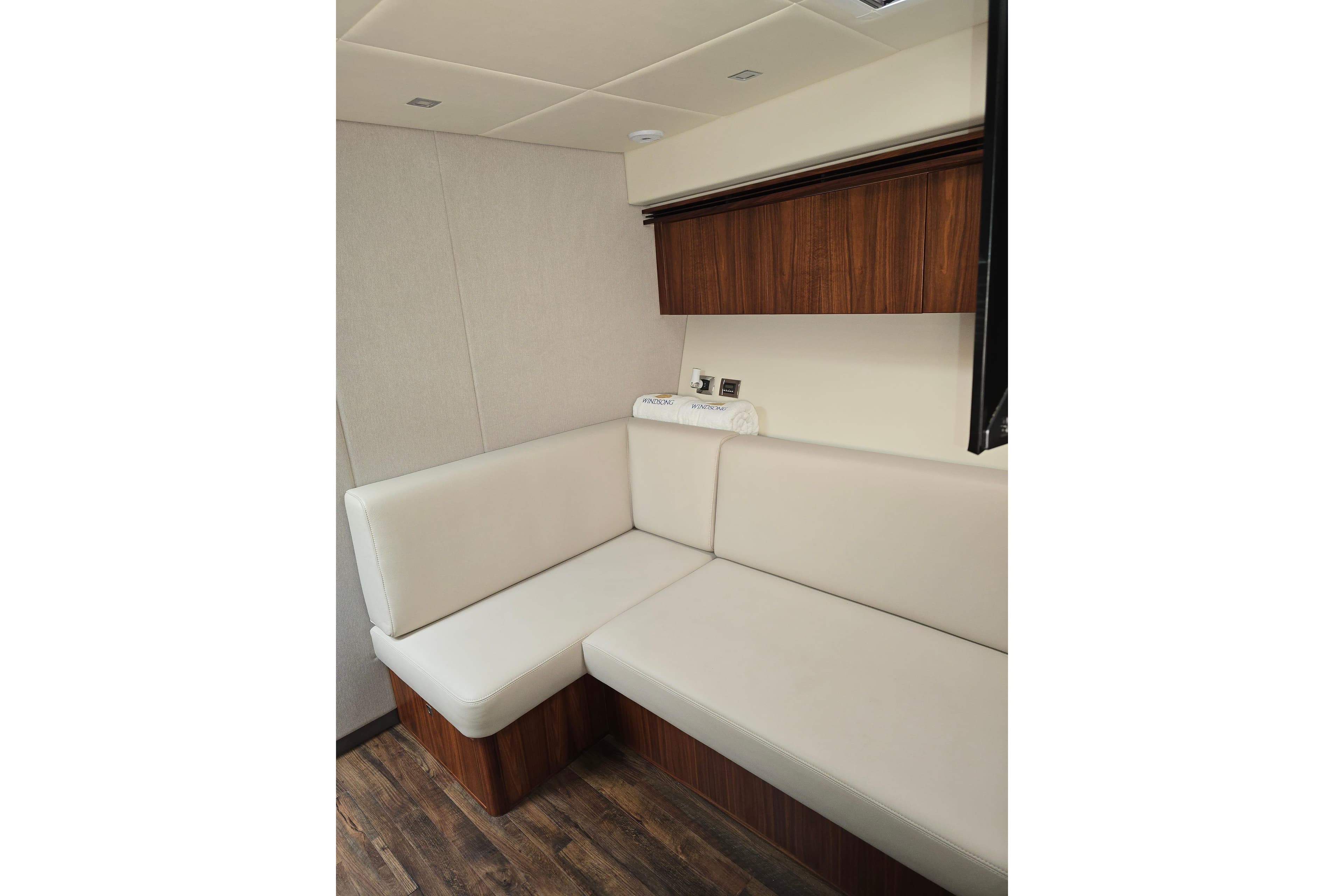Luxurious interior seating of 2019 Riviera 5400 Sport Yacht with wood accents.