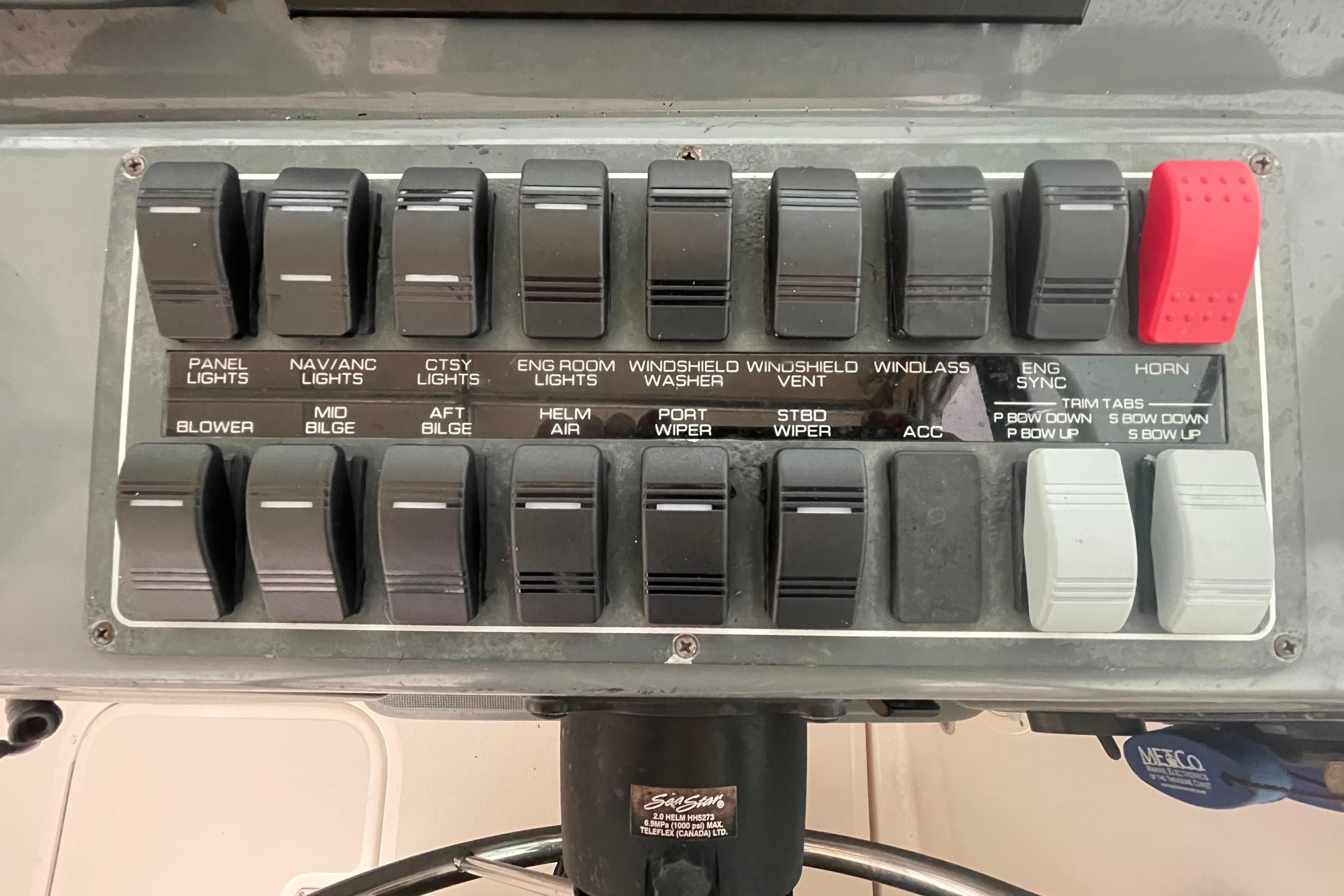 Control panel of a 2003 Tiara Yachts 3100 Open, featuring various switches and labels.