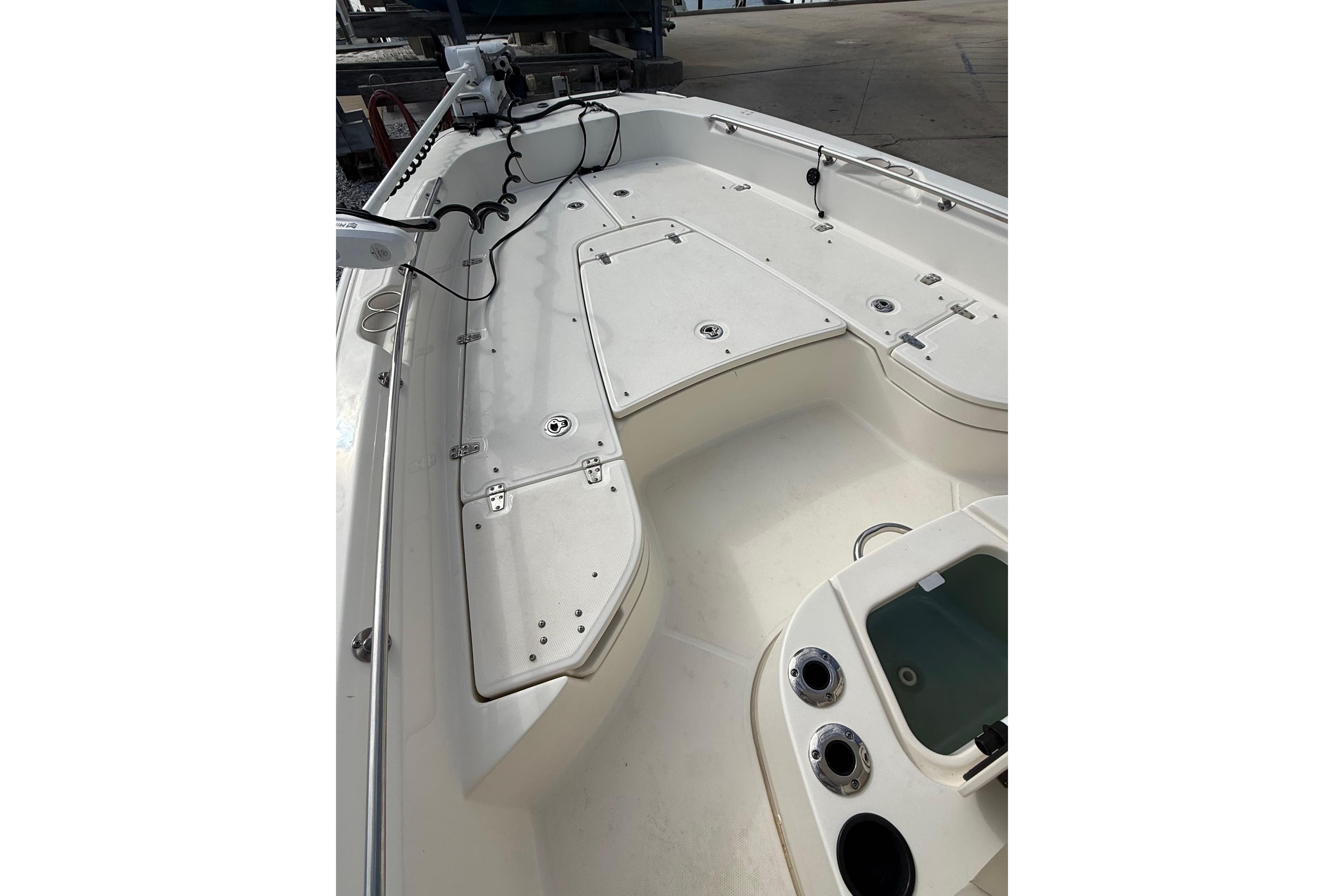 2020 Boston Whaler 240 Dauntless boat deck with storage compartments and fishing rod holders.