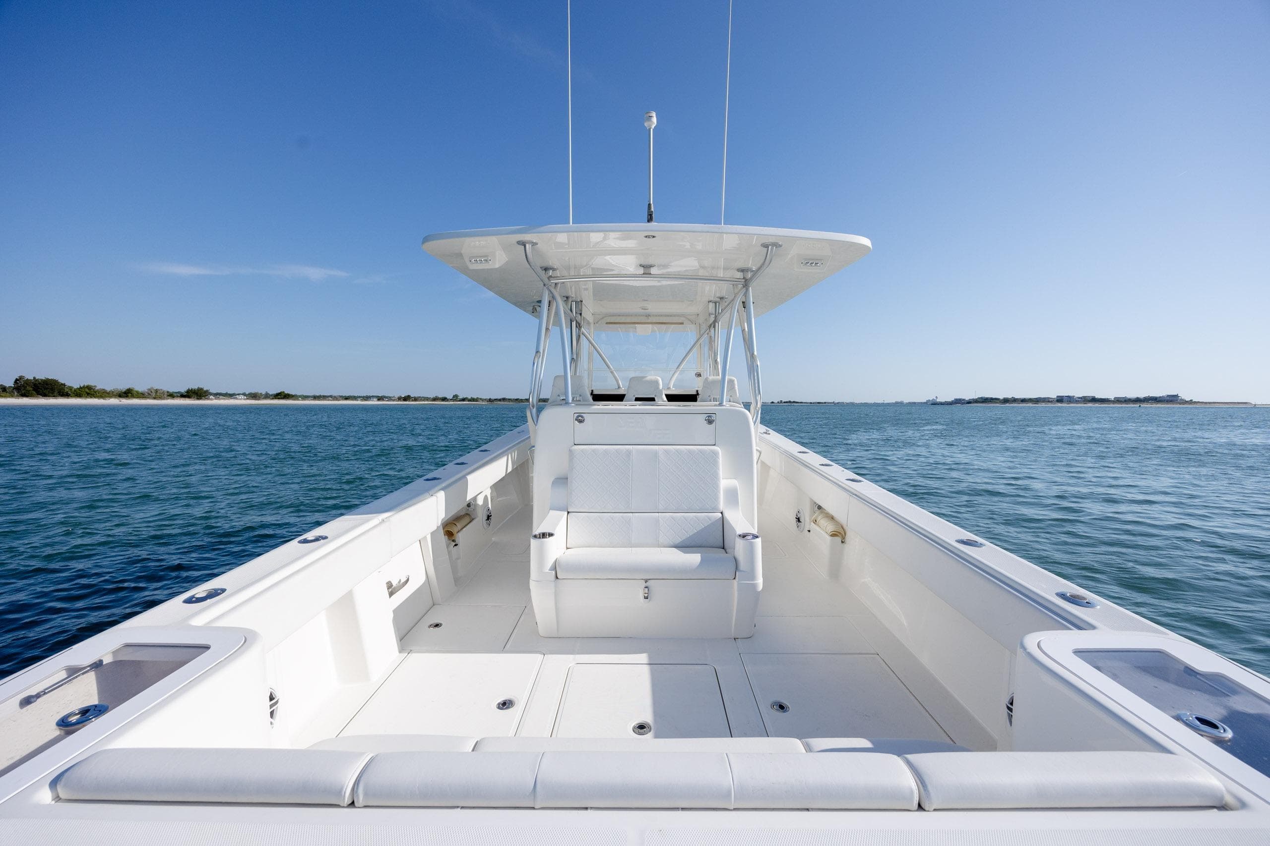 2019 SeaVee 370Z boat on calm water, featuring spacious deck and seating.