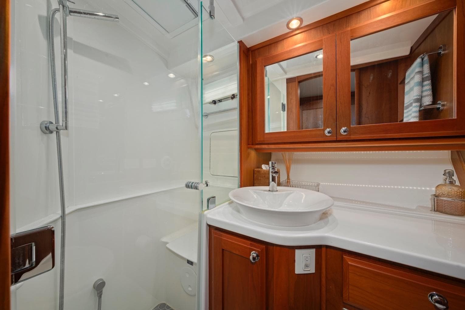Luxurious bathroom in 2019 Sabre 45 Salon Express yacht with wood cabinetry and modern fixtures.