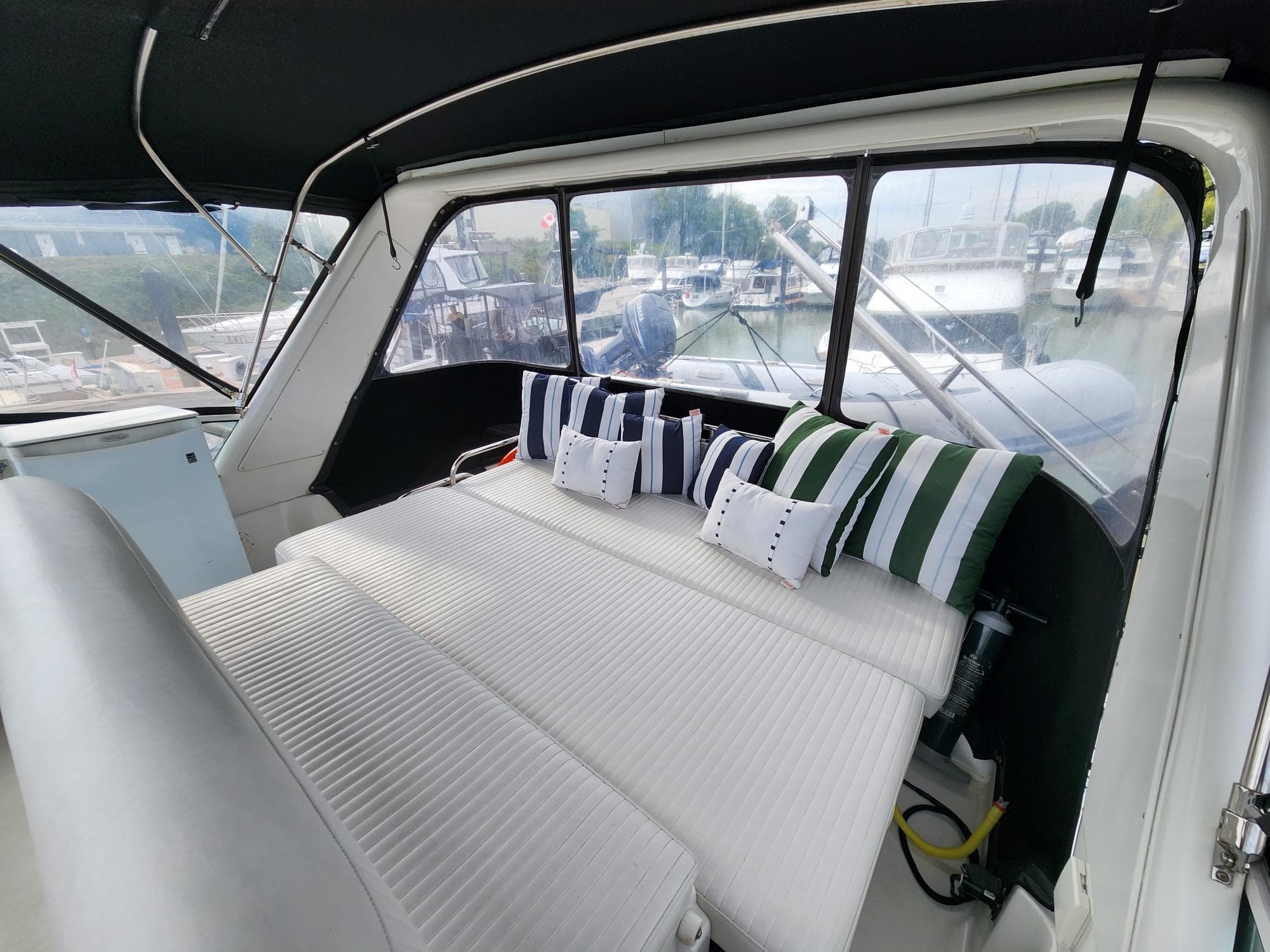 Interior of 2001 Navigator Californian 3900 yacht with striped cushions and large windows.