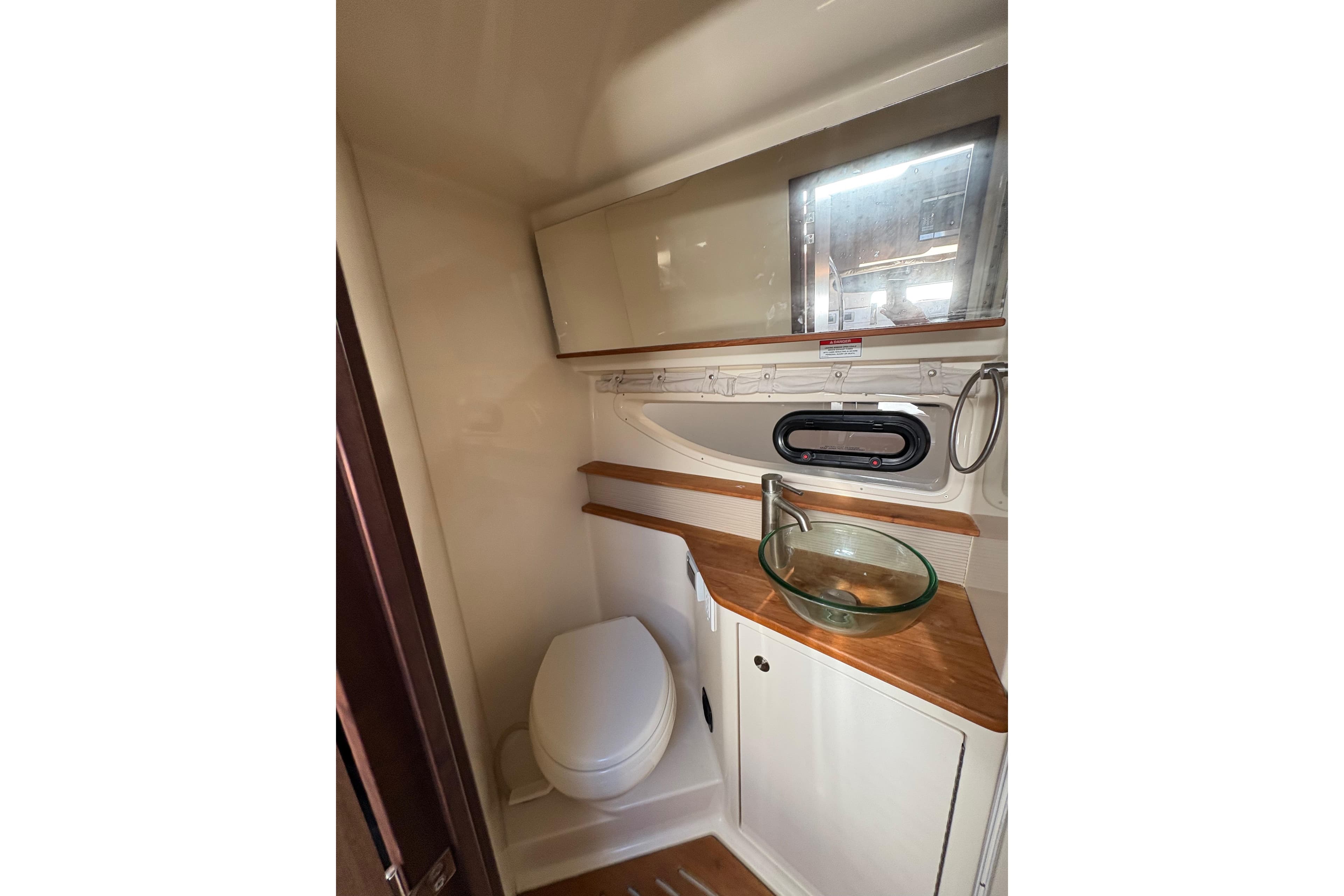 2018 Sea Ray Sundancer 350 Coupe bathroom with modern sink and wooden accents.